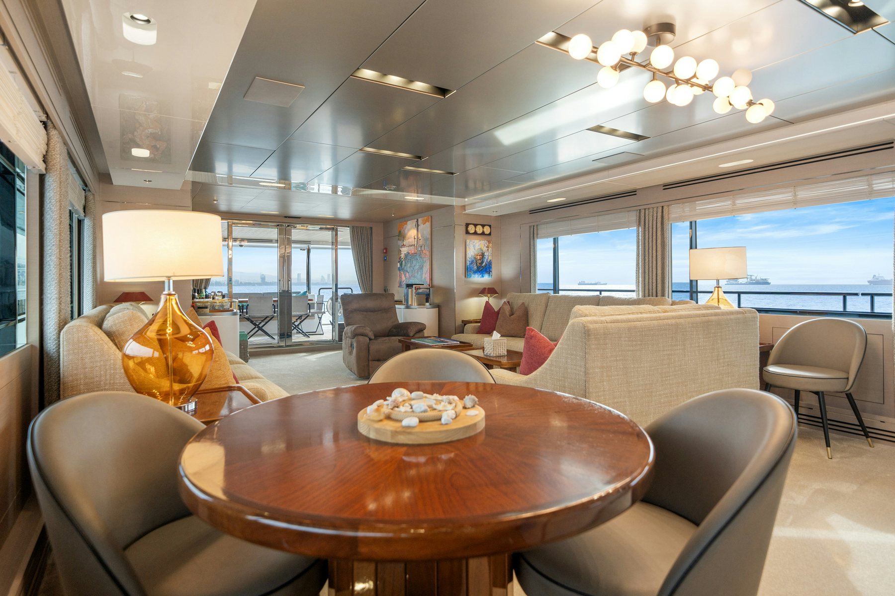 a living room with a large table and chairs aboard CAPE COD II Yacht for Sale
