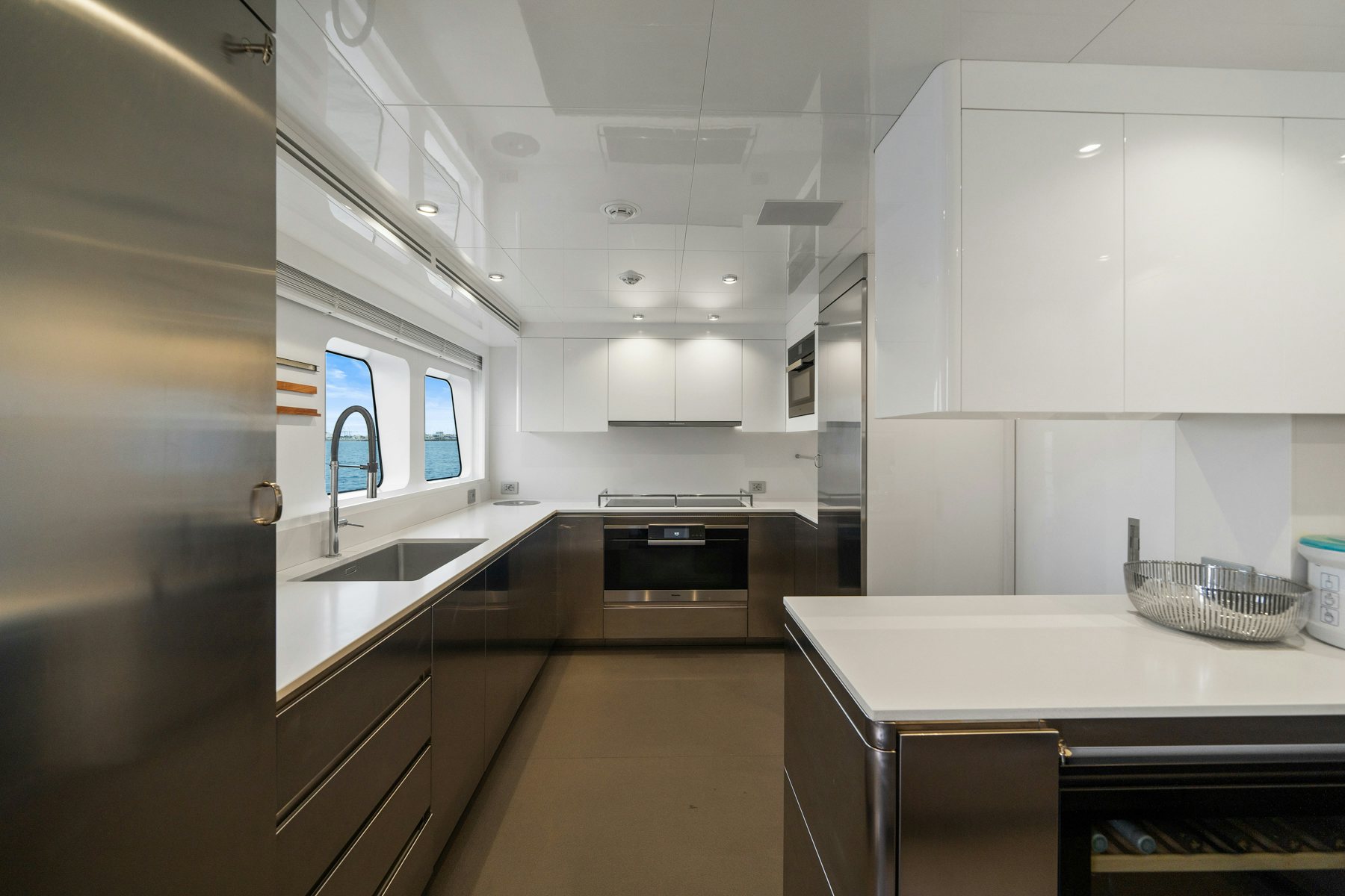 a kitchen with white cabinets aboard CAPE COD II Yacht for Sale