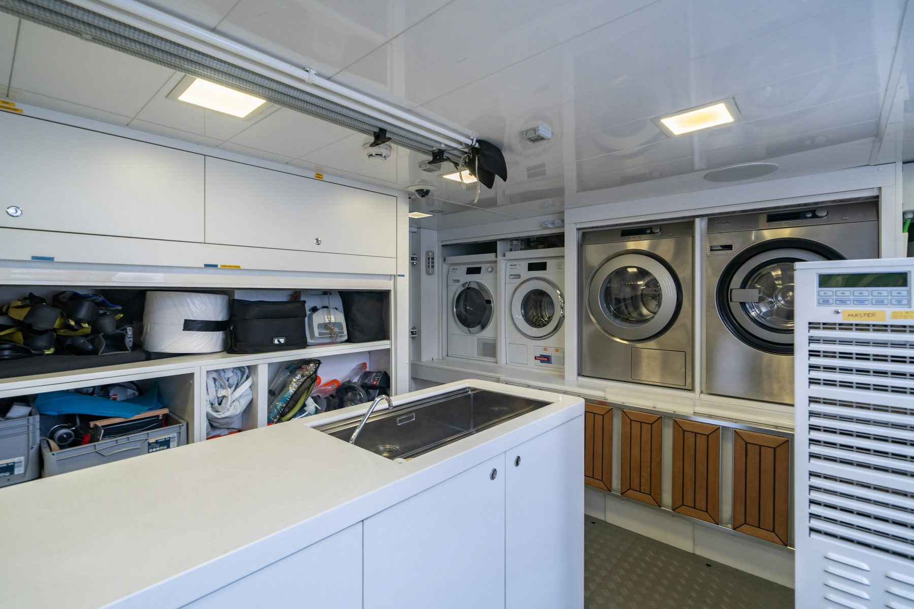 a kitchen with white cabinets aboard CAPE COD II Yacht for Sale