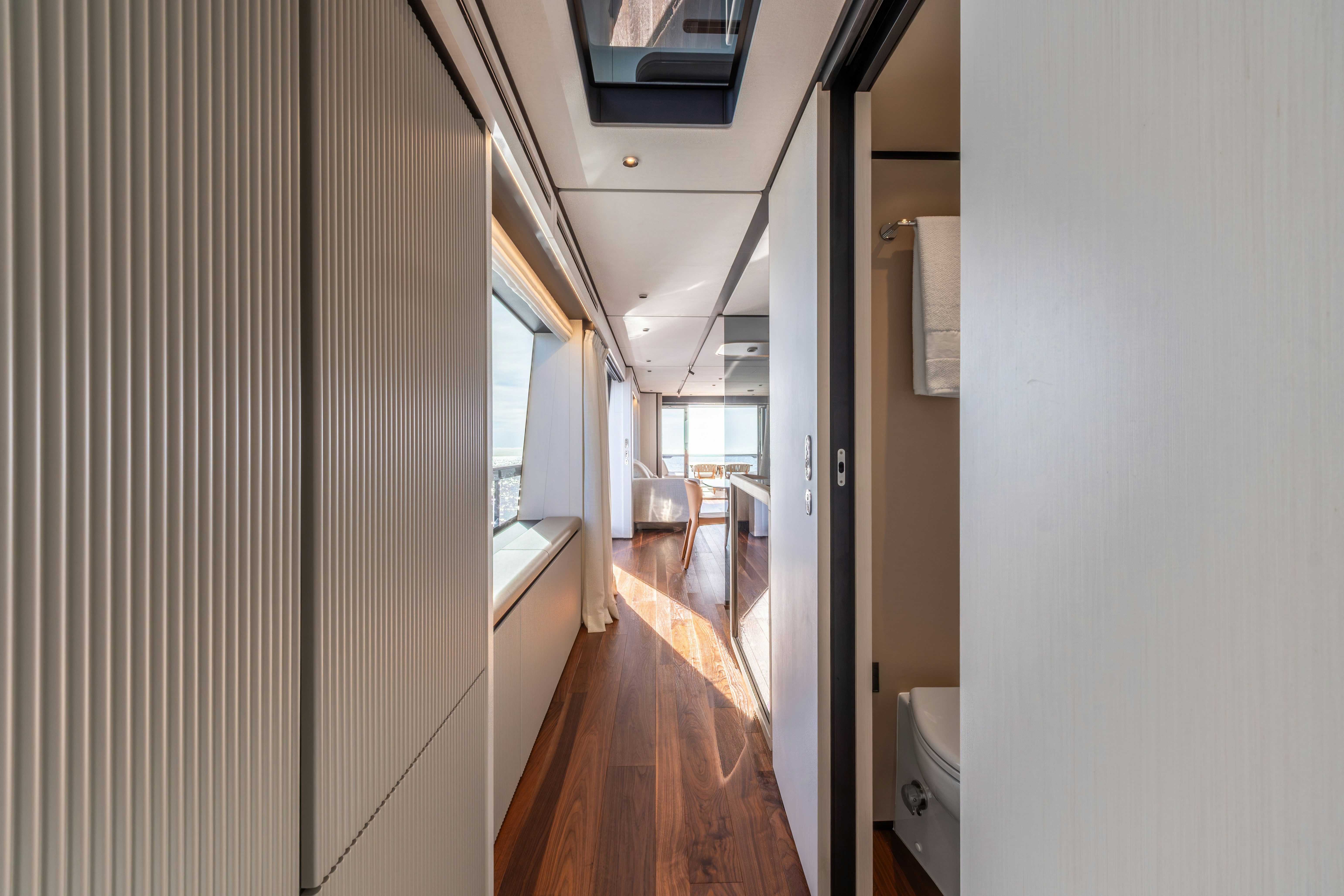 a hallway with a wood floor and a window aboard TOGETHER Yacht for Sale
