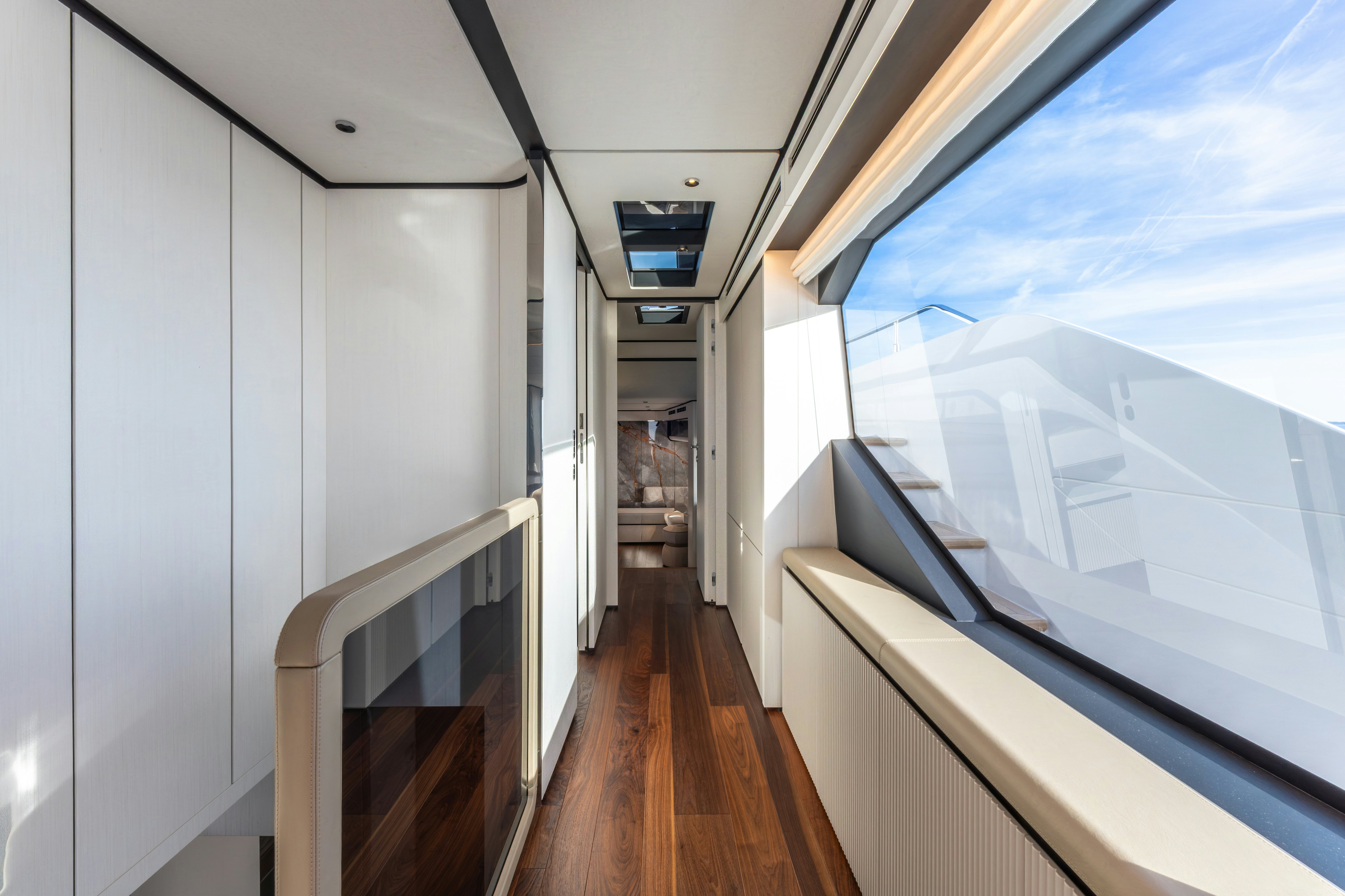 a long hallway with a window aboard TOGETHER Yacht for Sale