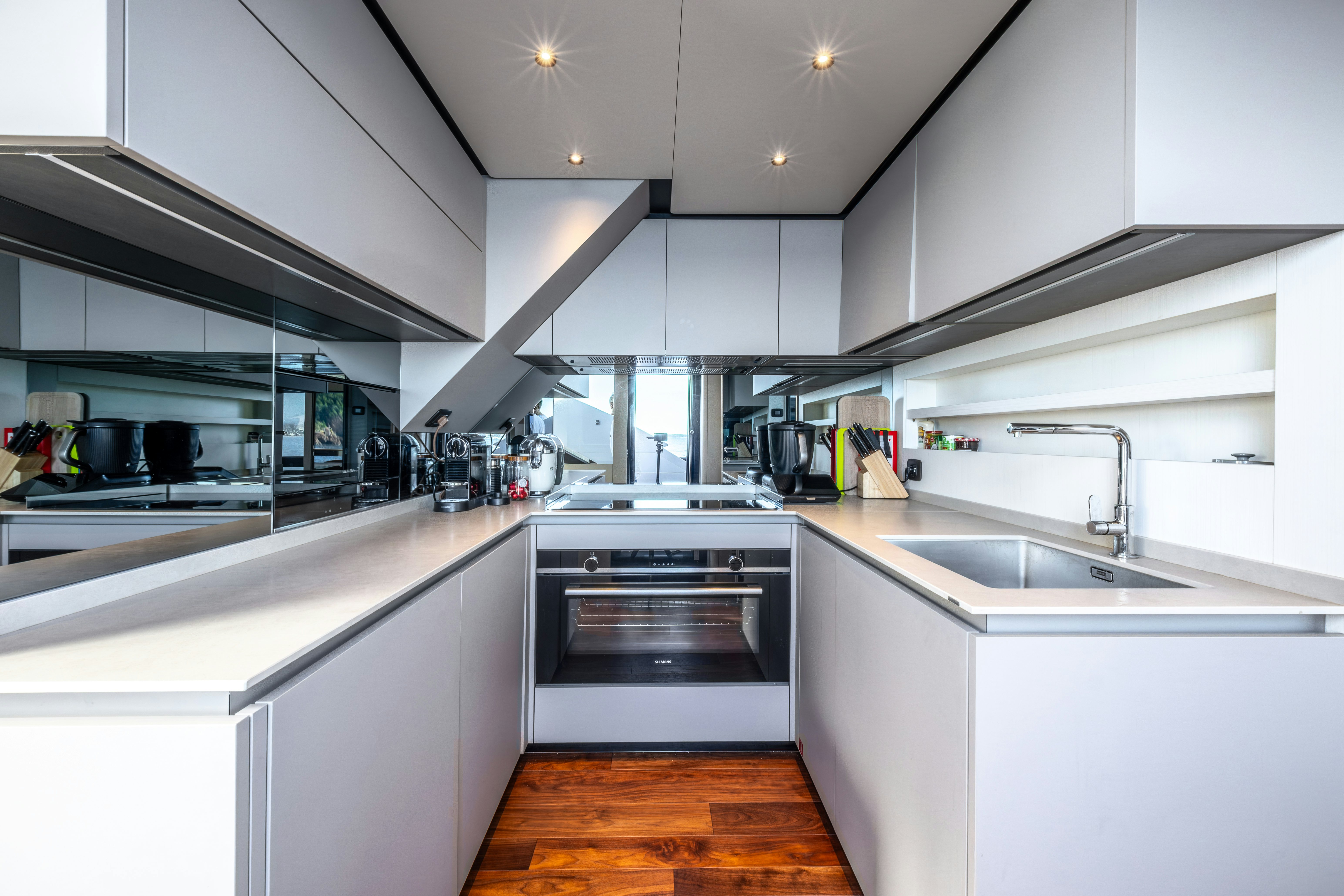 a kitchen with white cabinets aboard TOGETHER Yacht for Sale
