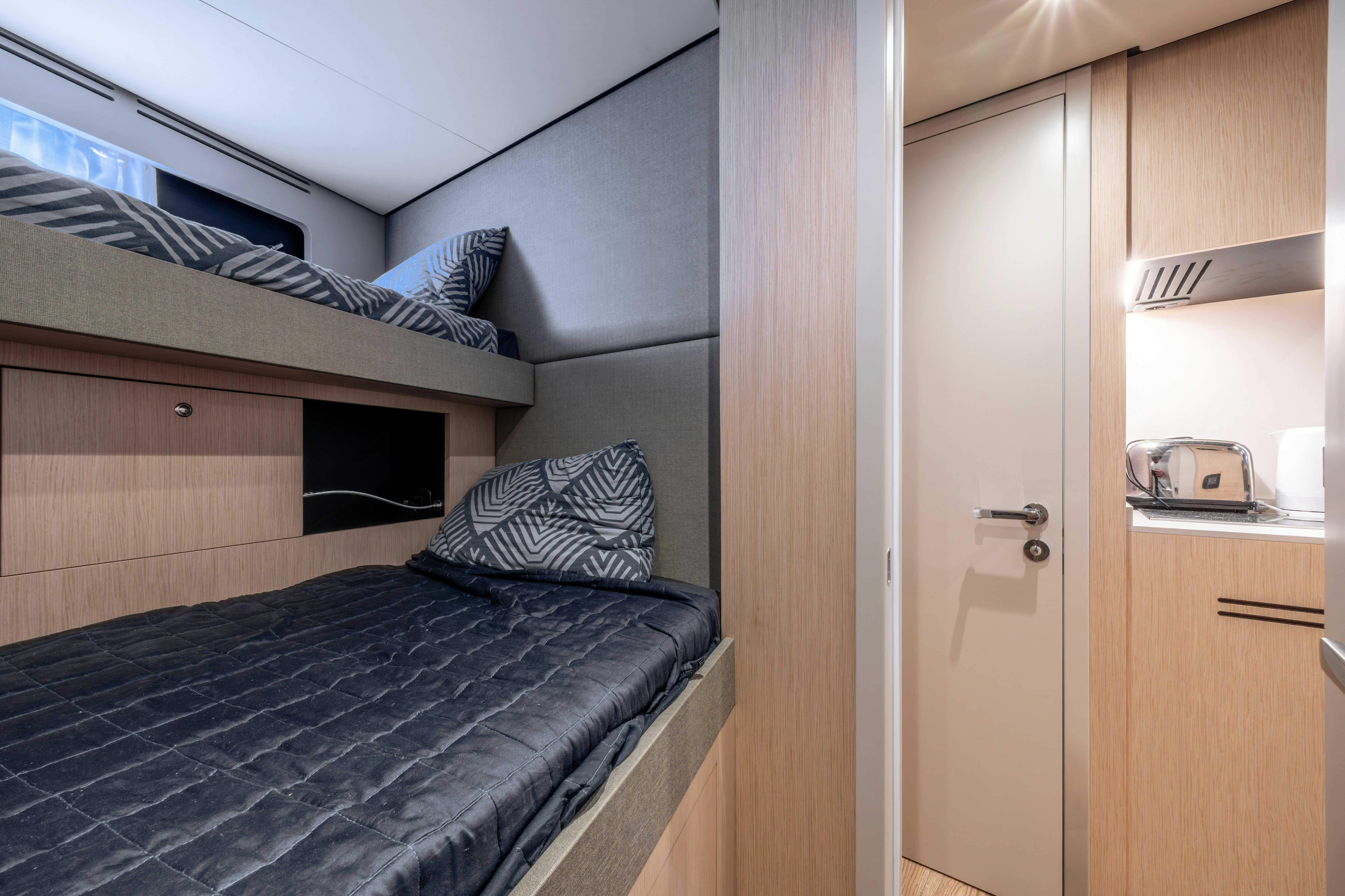 a bedroom with a bed and a door aboard TOGETHER Yacht for Sale