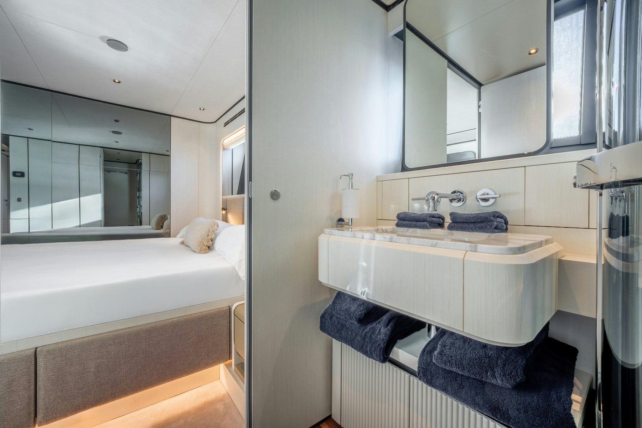 a bathroom with a sink and a bed aboard TOGETHER Yacht for Charter