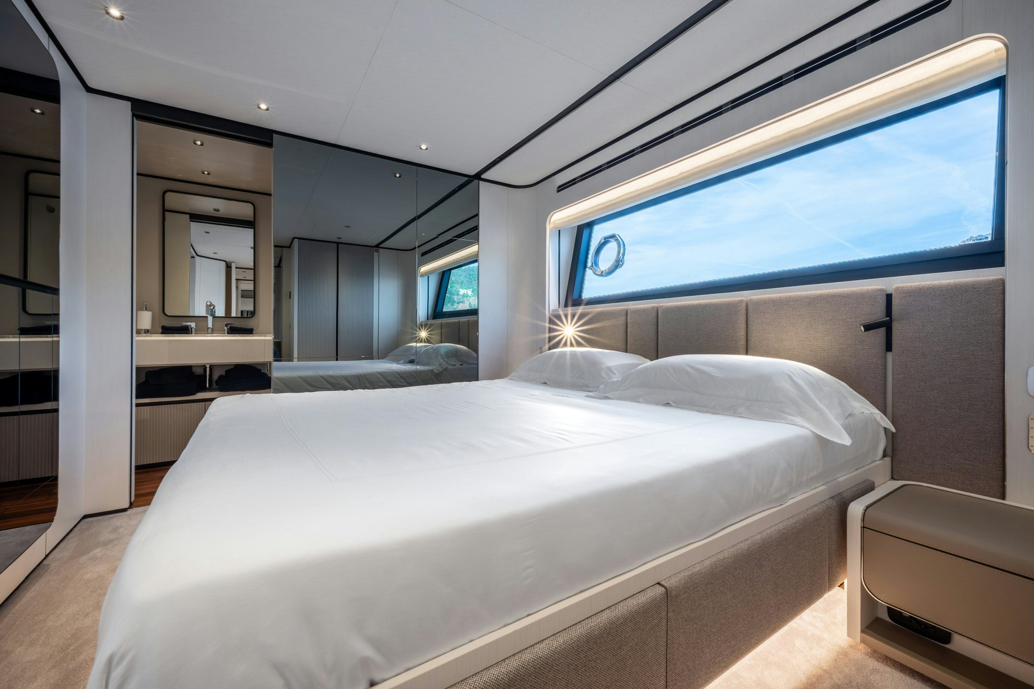 a room with a bed and a window aboard TOGETHER Yacht for Charter