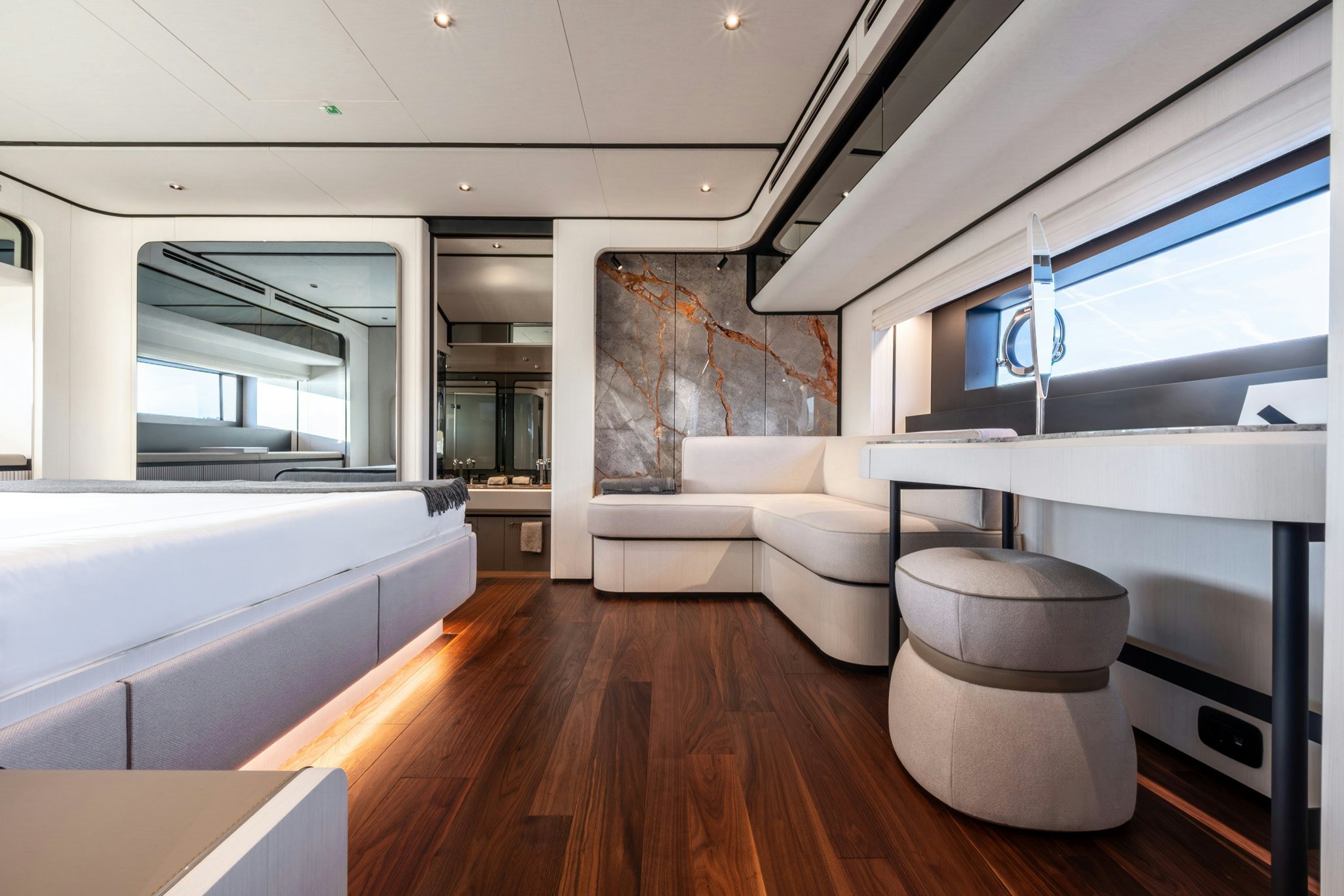 a room with a wood floor and white couches aboard TOGETHER Yacht for Charter