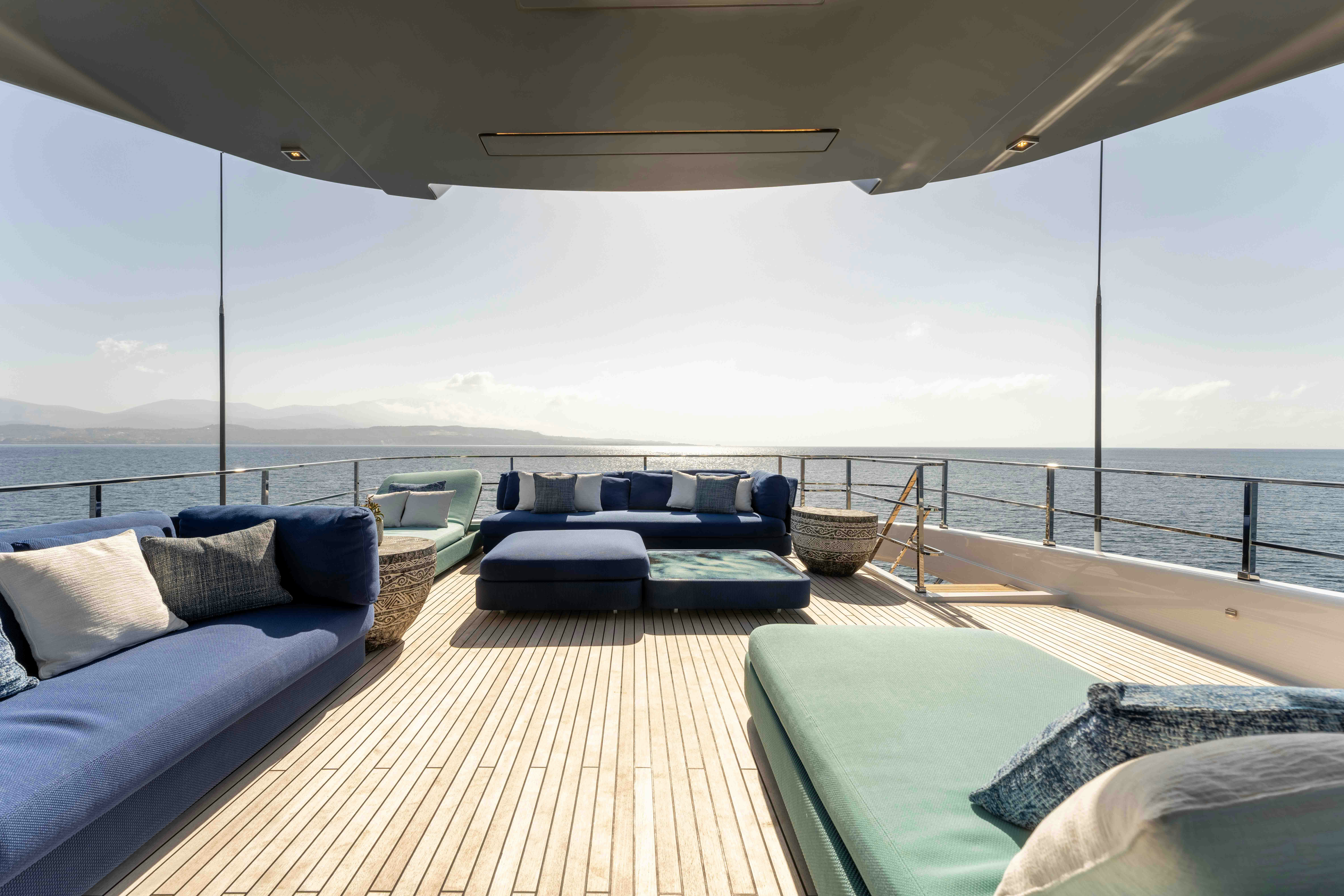 a large lounge area with a large deck and a large body of water aboard RENEWAL 3 Yacht for Sale