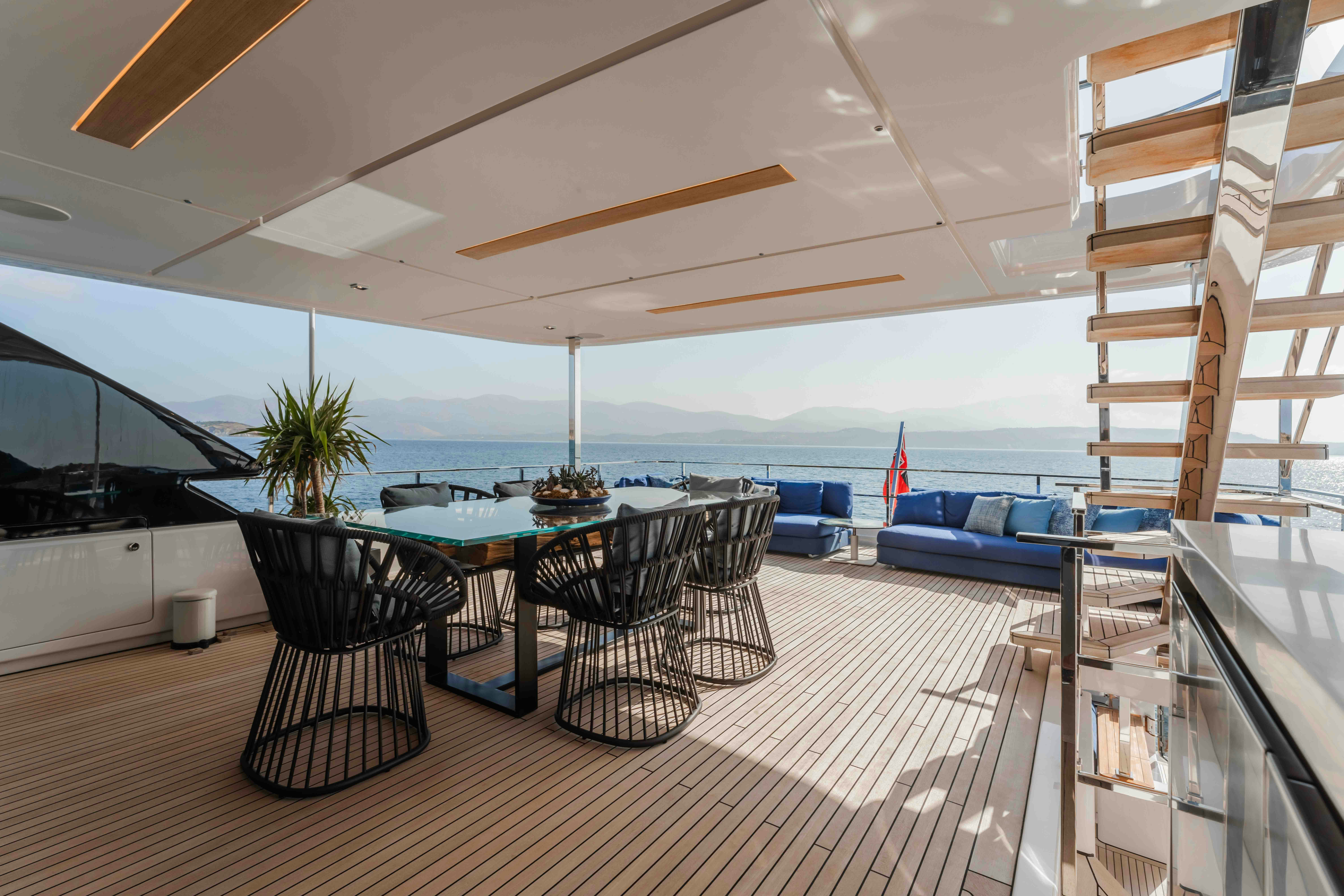 a large room with a table and chairs and a large body of water aboard RENEWAL 3 Yacht for Sale