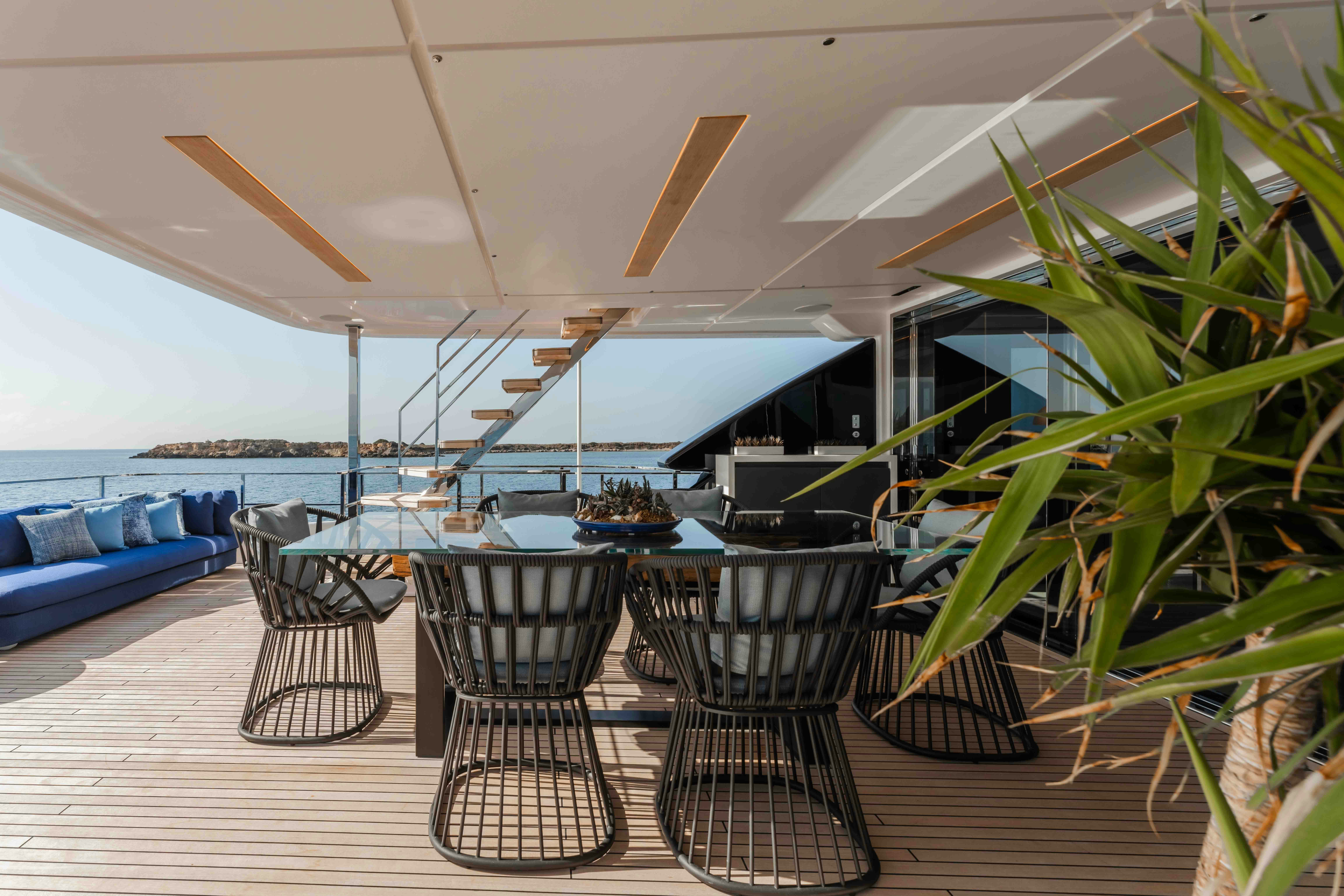 a patio with a table and chairs aboard RENEWAL 3 Yacht for Sale