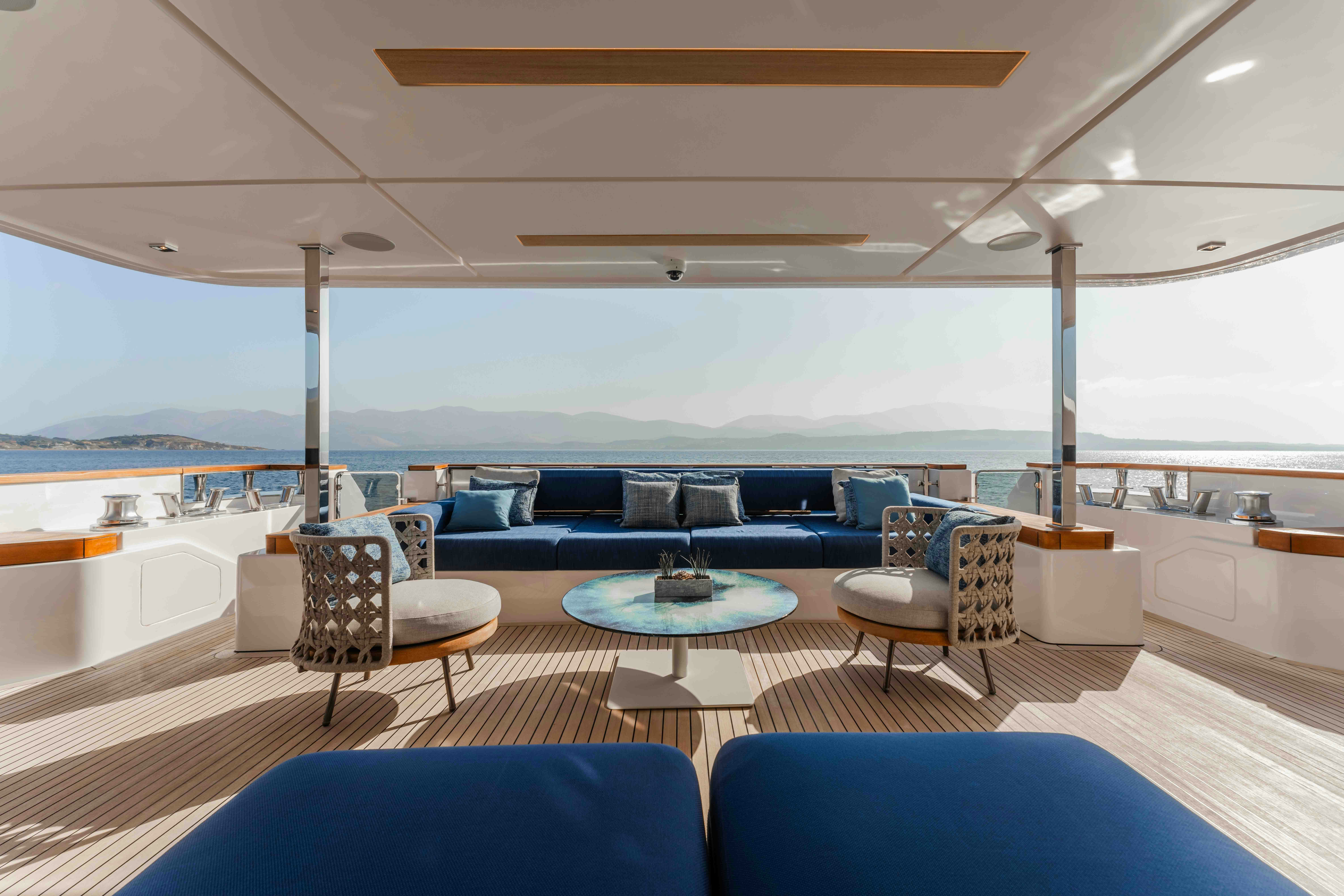 a room with a table and chairs aboard RENEWAL 3 Yacht for Sale