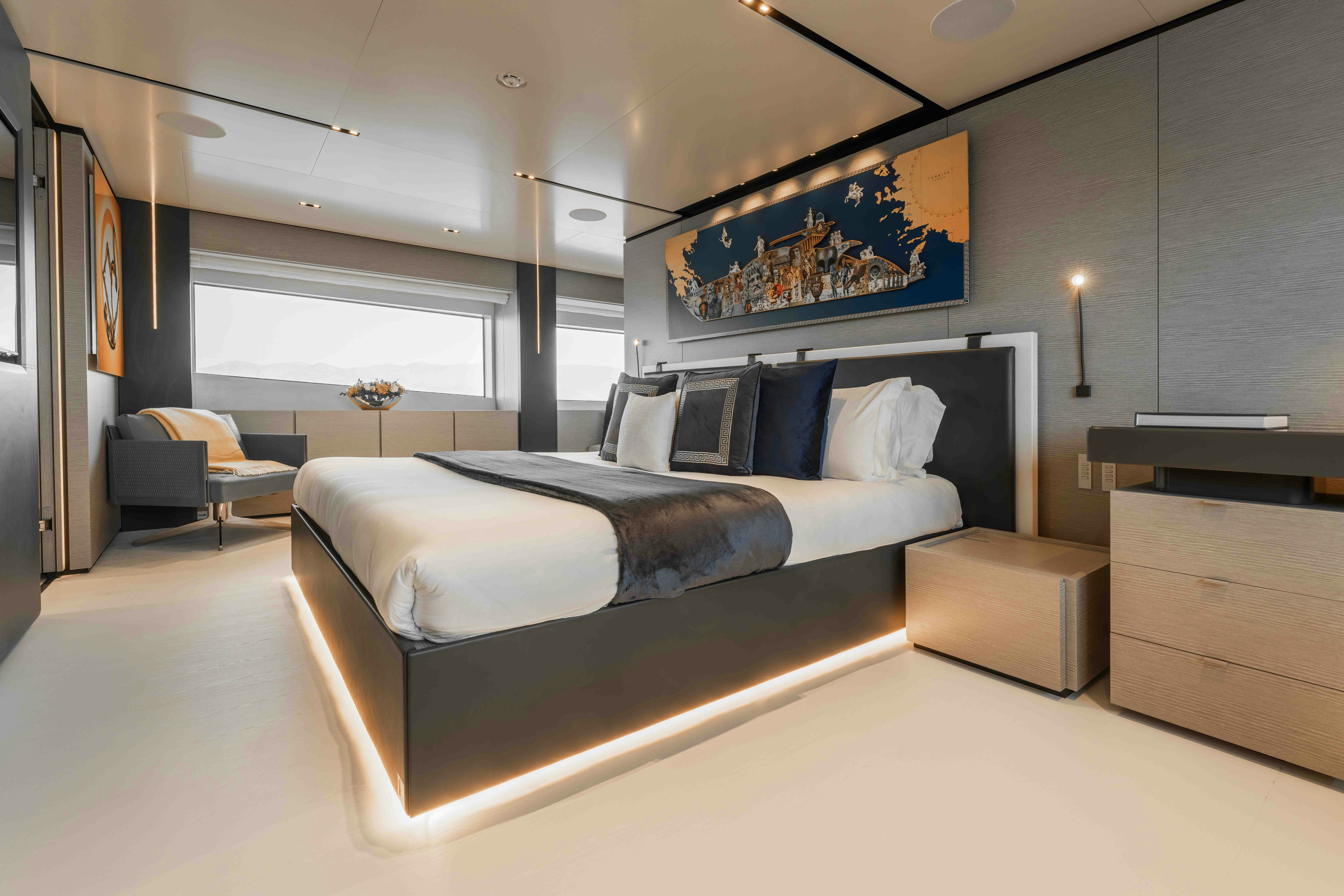a bedroom with a bed and a desk aboard RENEWAL 3 Yacht for Sale