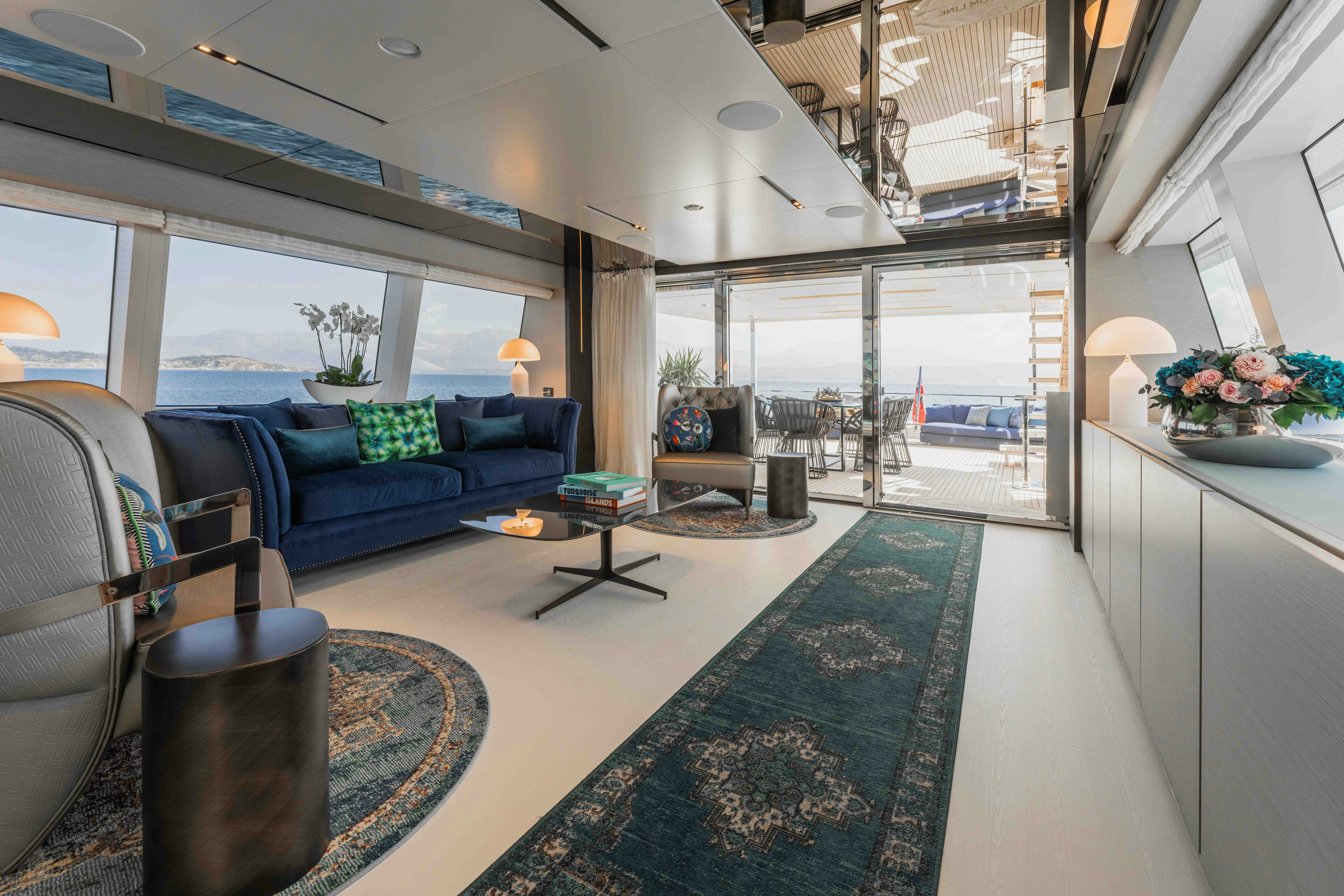 a living room with a blue couch aboard RENEWAL 3 Yacht for Sale