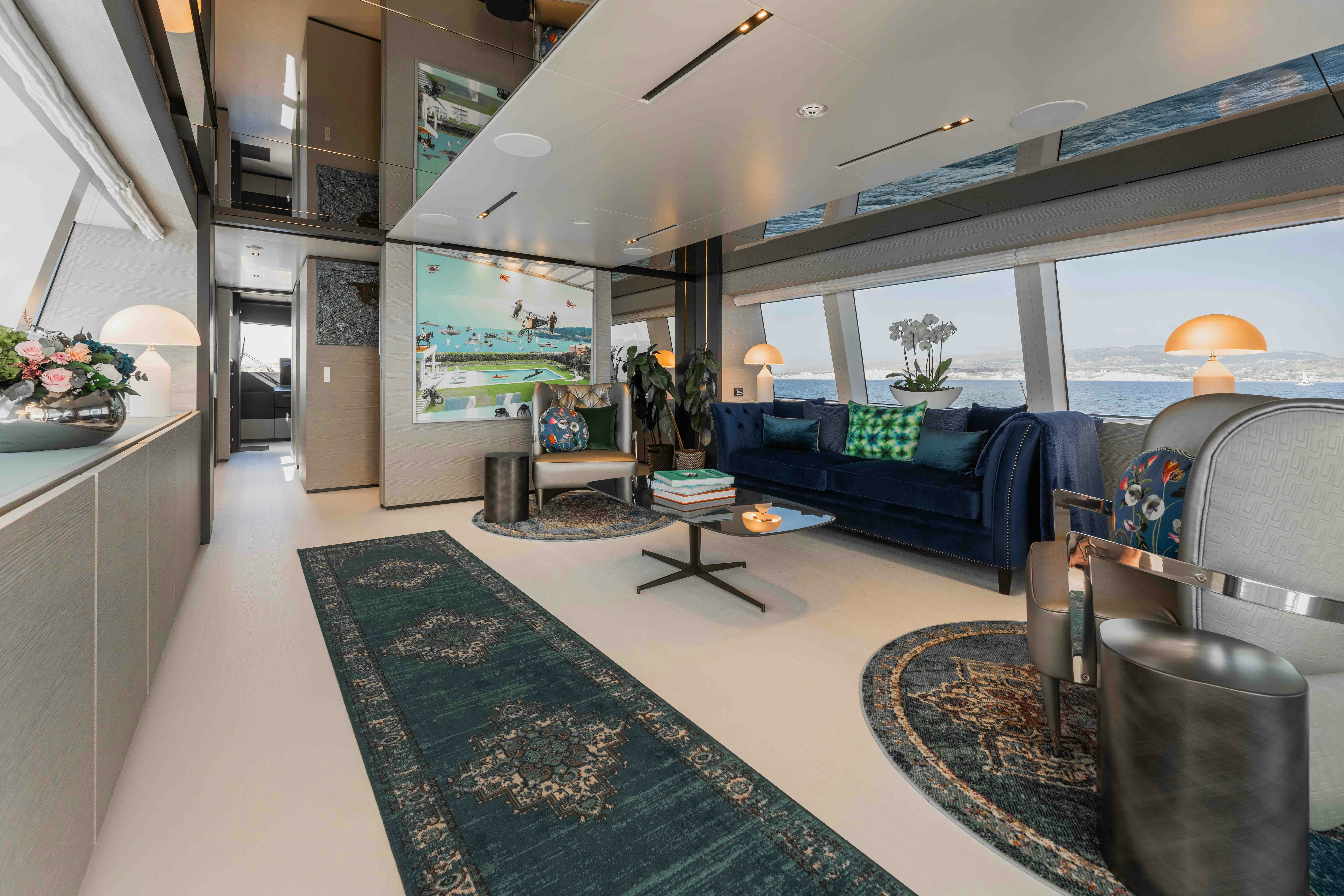 a living room with a blue couch aboard RENEWAL 3 Yacht for Sale