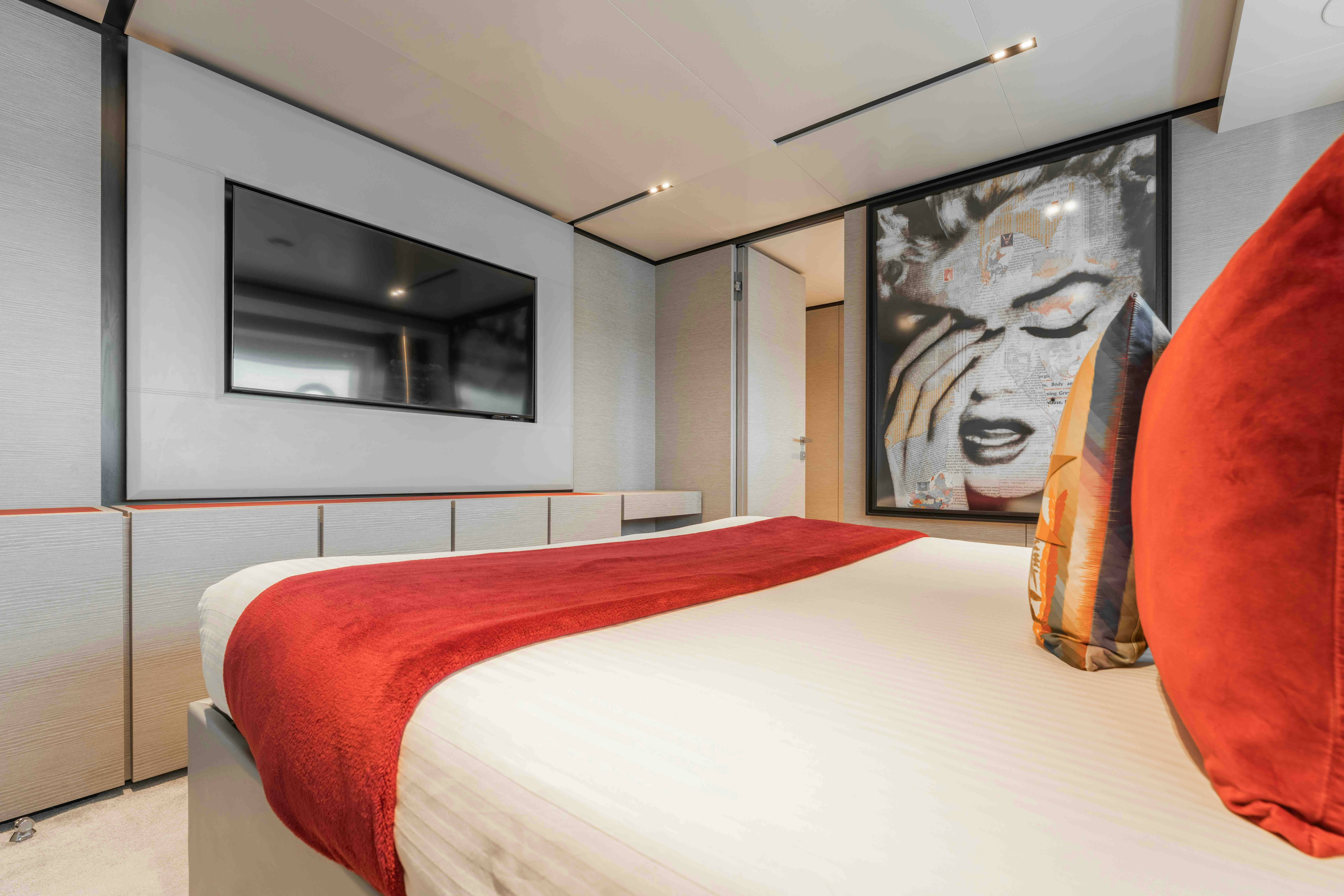 a bed with a painting on the wall aboard RENEWAL 3 Yacht for Sale
