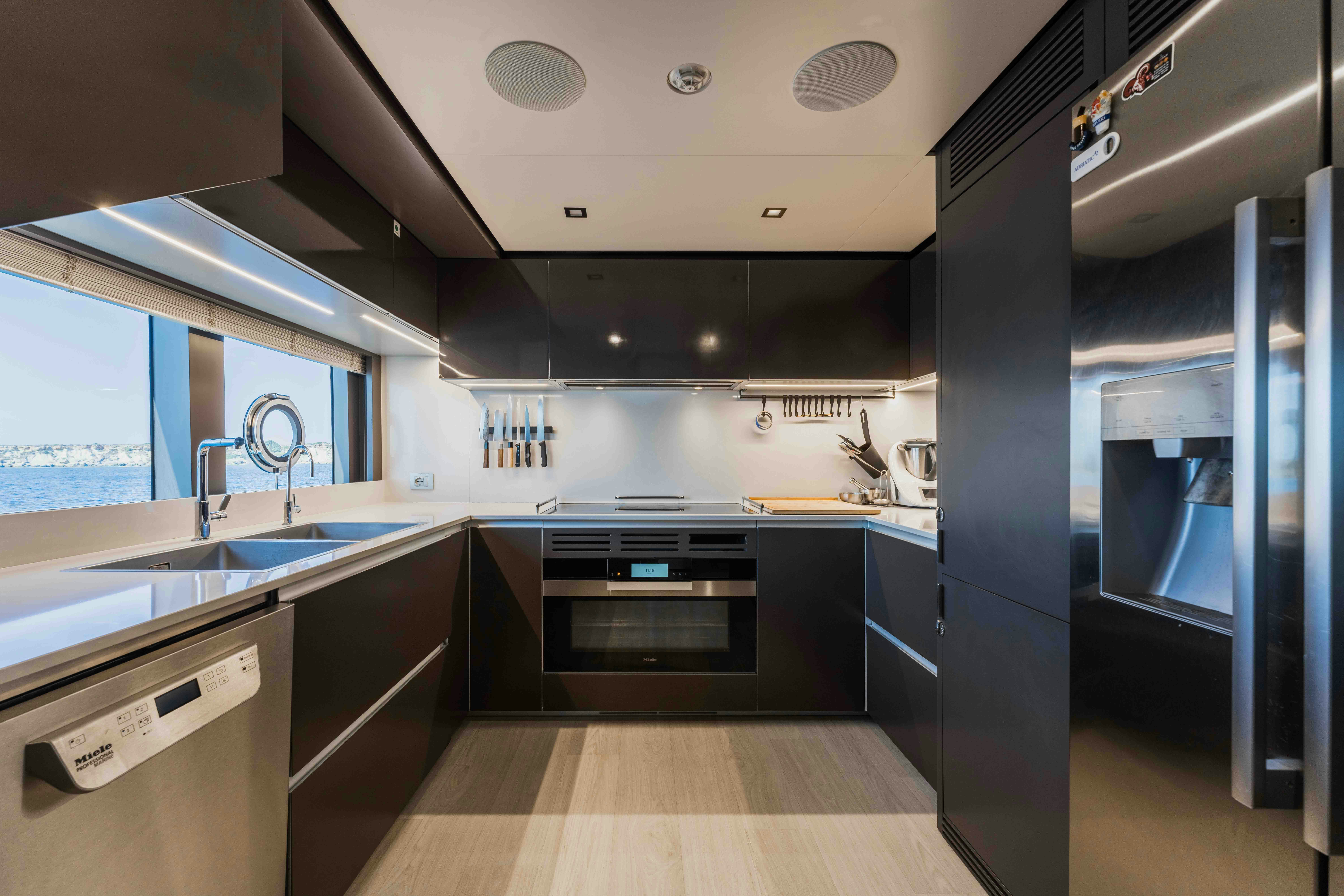 a kitchen with a large sink and cabinets aboard RENEWAL 3 Yacht for Sale