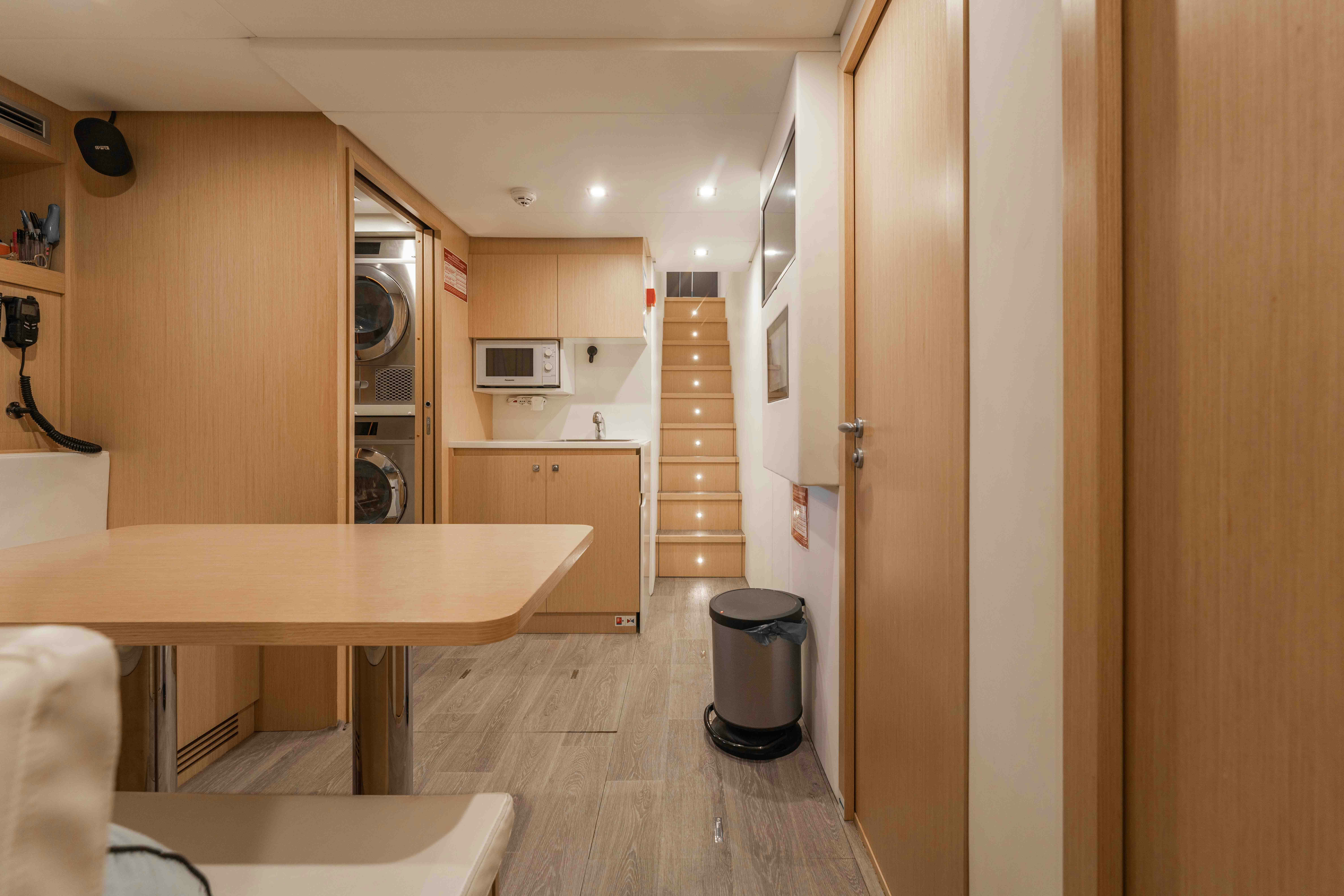 a kitchen with a wood floor aboard RENEWAL 3 Yacht for Sale