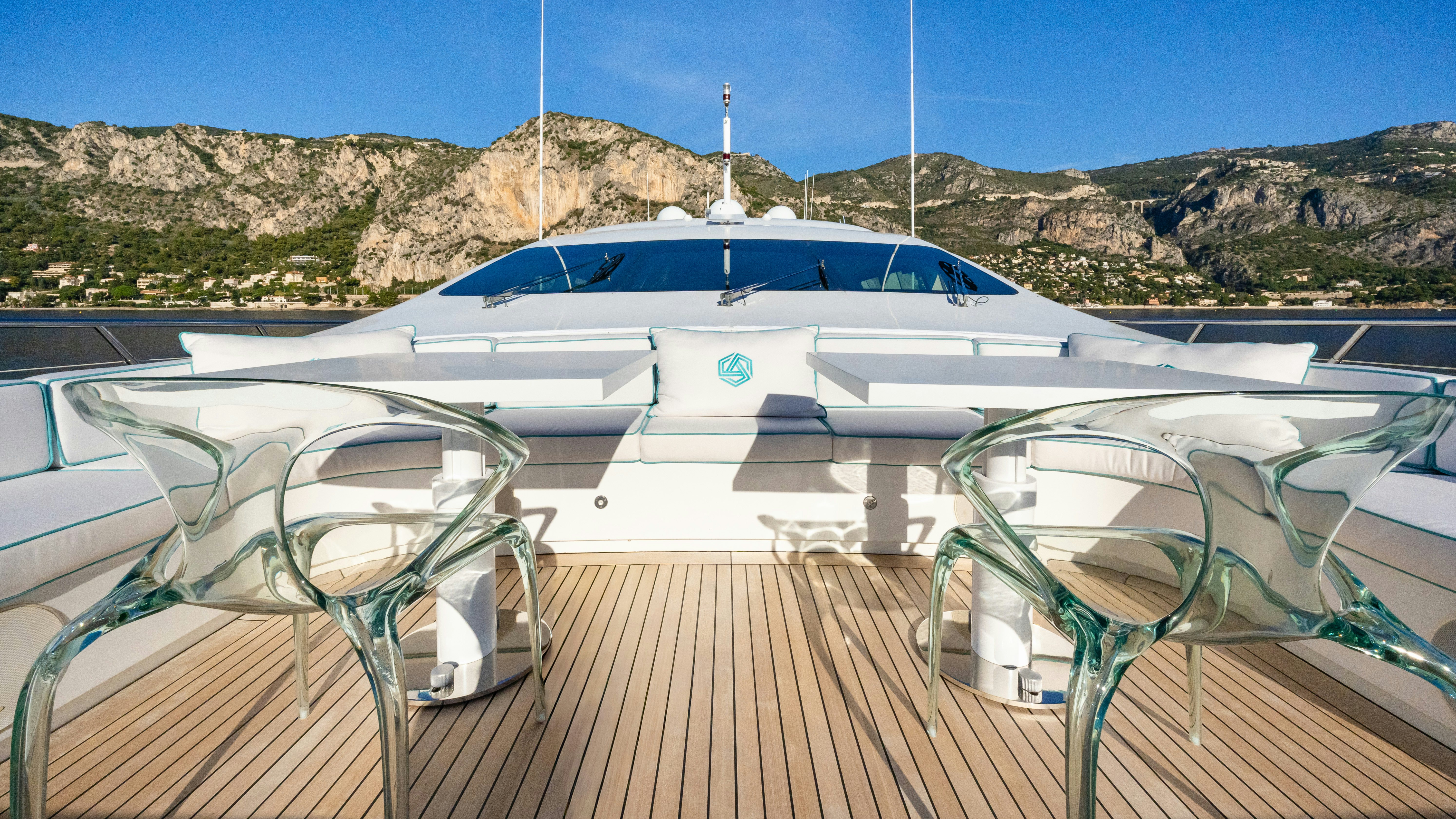 a deck with chairs and a boat on it aboard BLUE AZUR Yacht for Sale