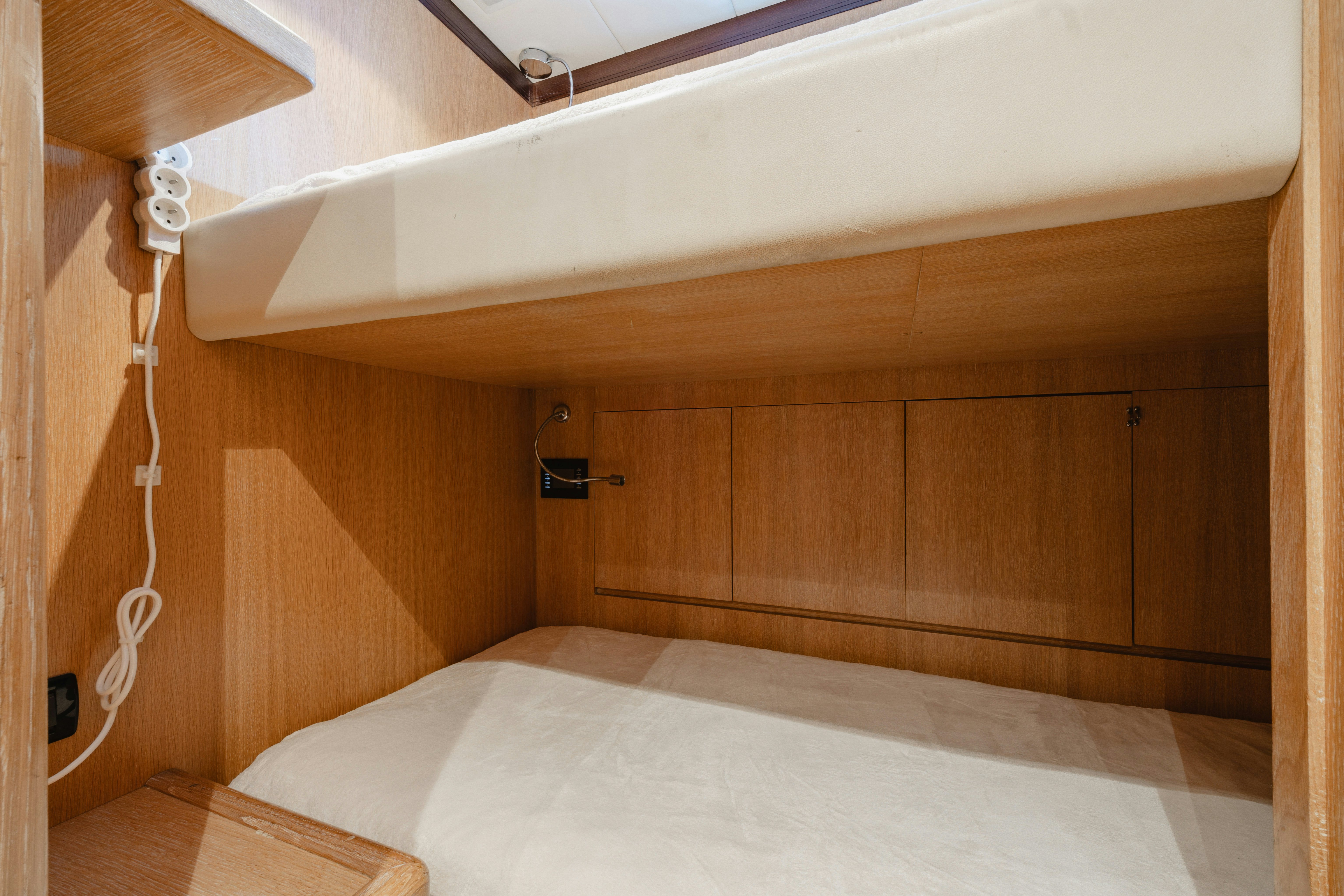 a wooden room with a bed aboard BLUE AZUR Yacht for Sale
