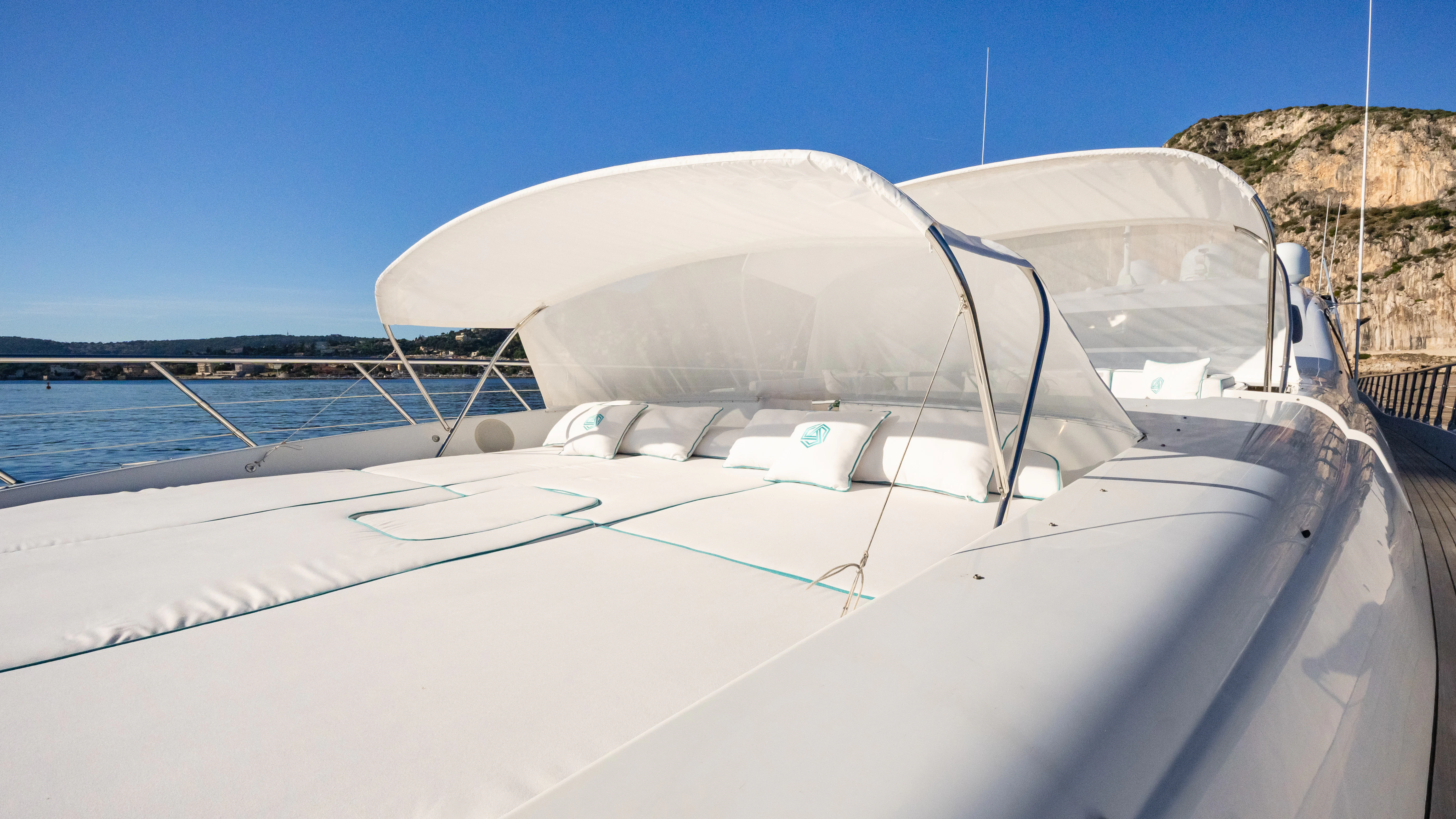 a white boat on a body of water aboard BLUE AZUR Yacht for Charter