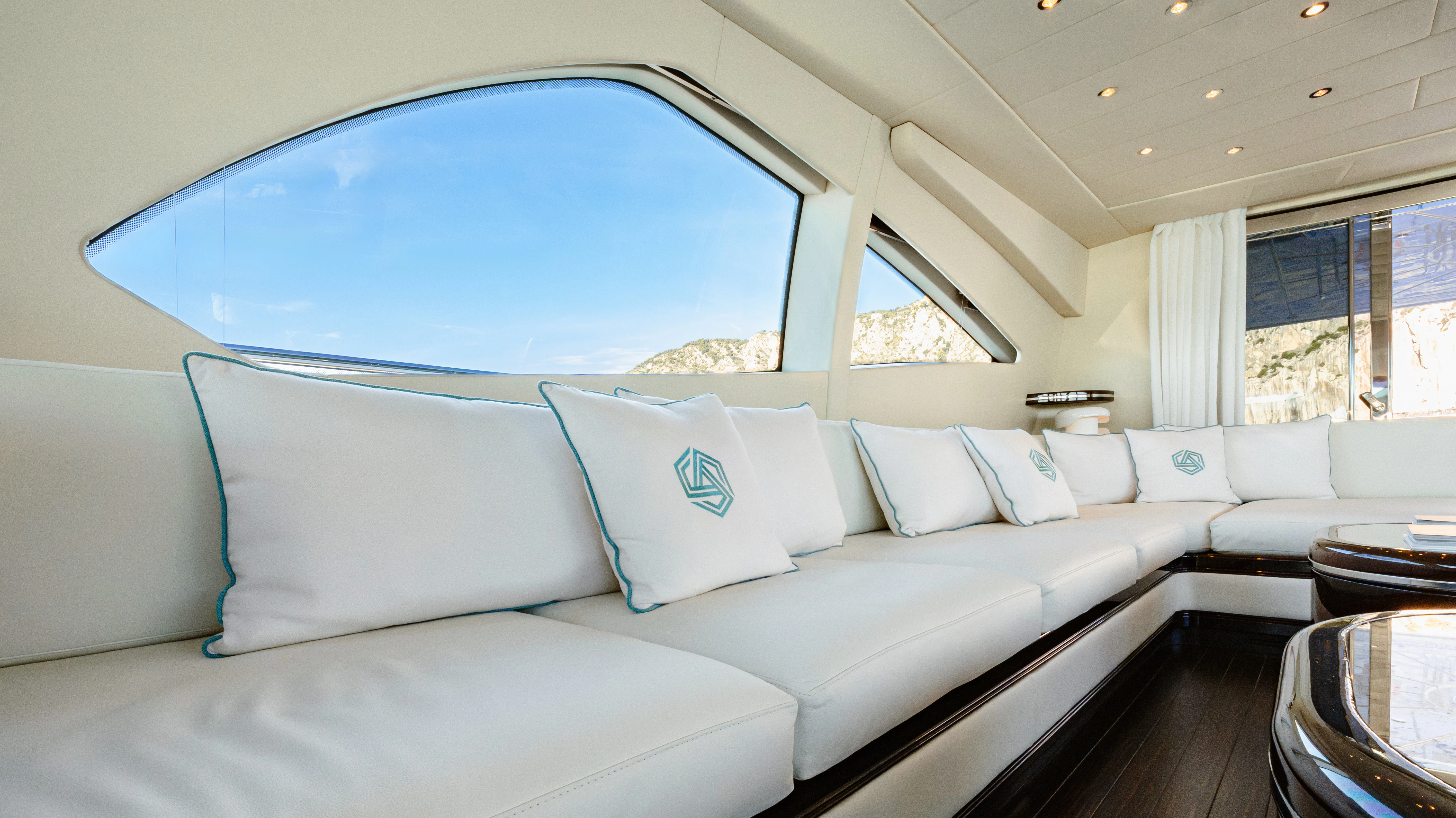 a large white bed with a blue tent behind it aboard BLUE AZUR Yacht for Charter