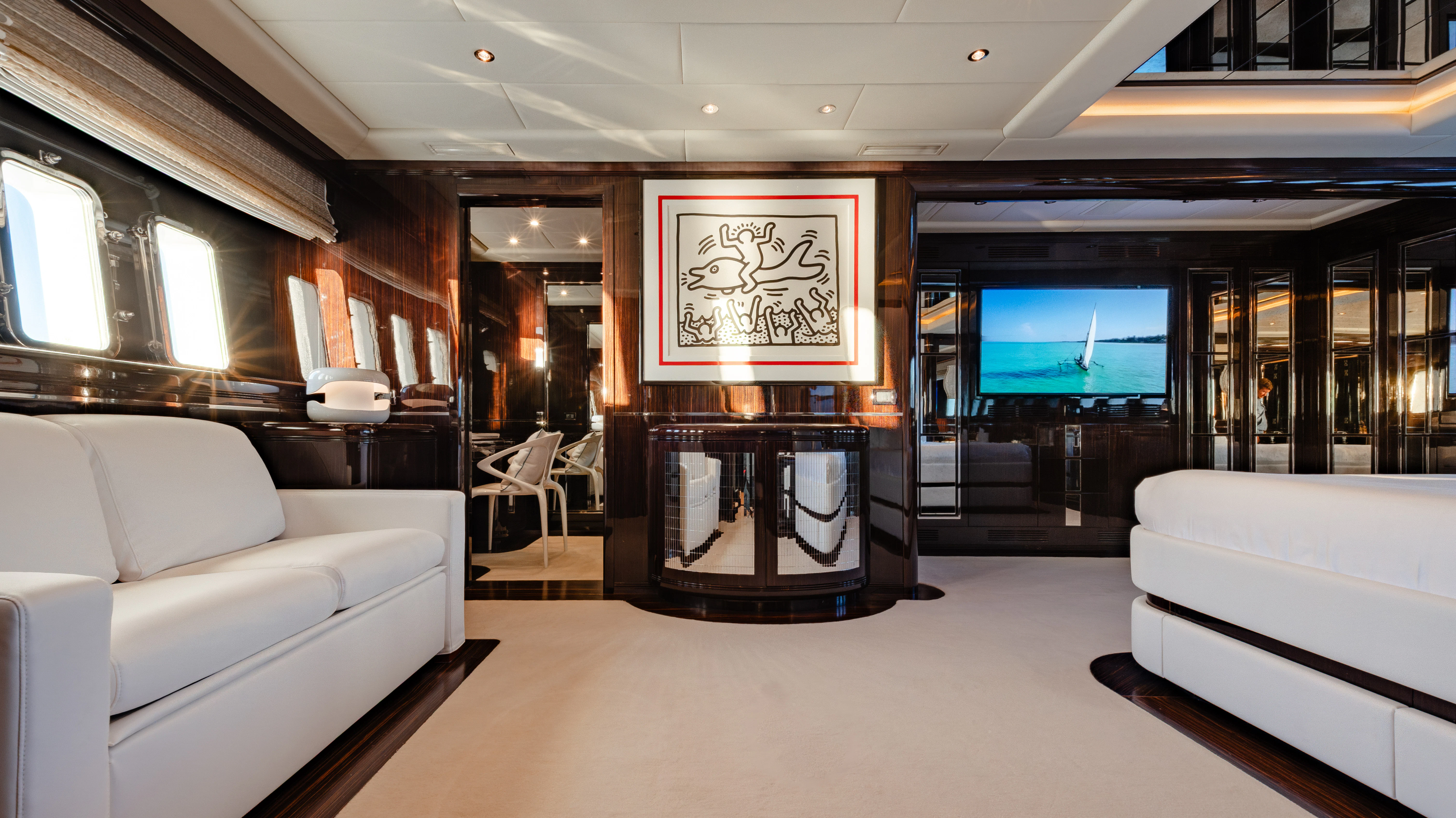 a room with a couch and a television aboard BLUE AZUR Yacht for Charter