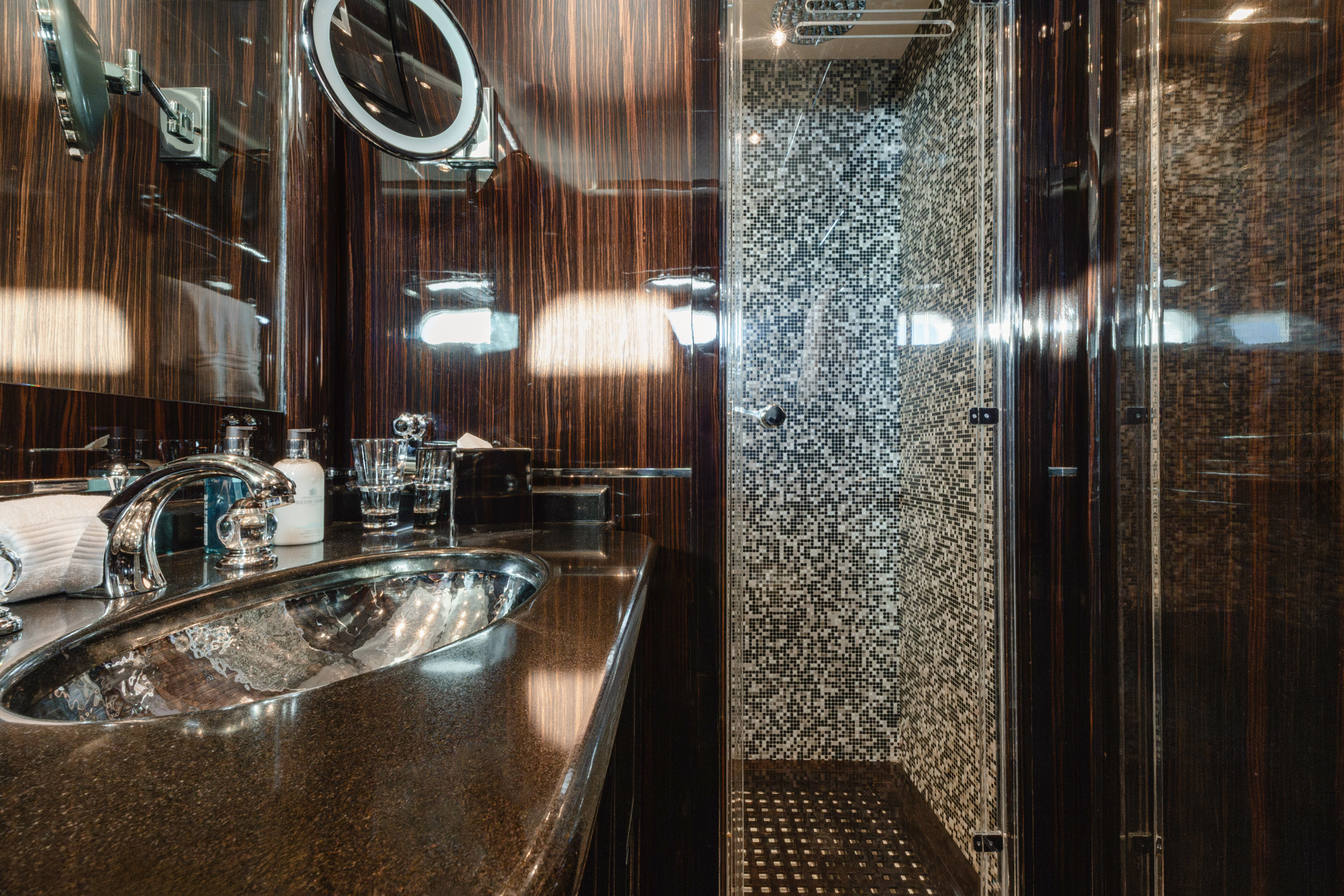 a bathroom with a sink and a shower aboard BLUE AZUR Yacht for Charter