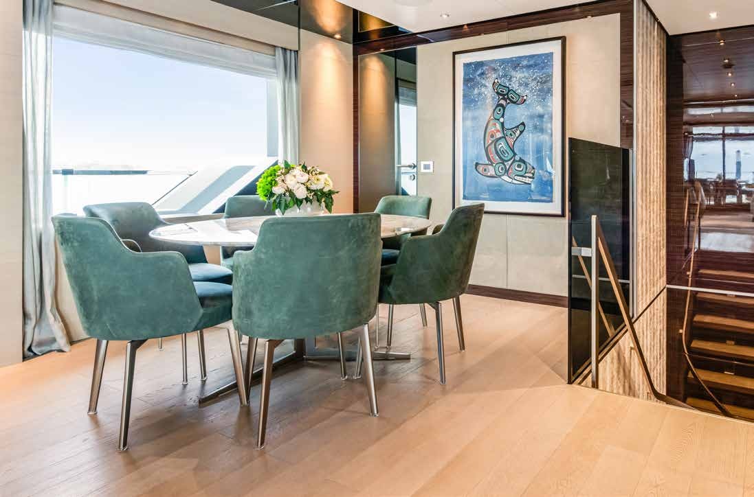 a room with a table and chairs aboard NURI Yacht for Charter