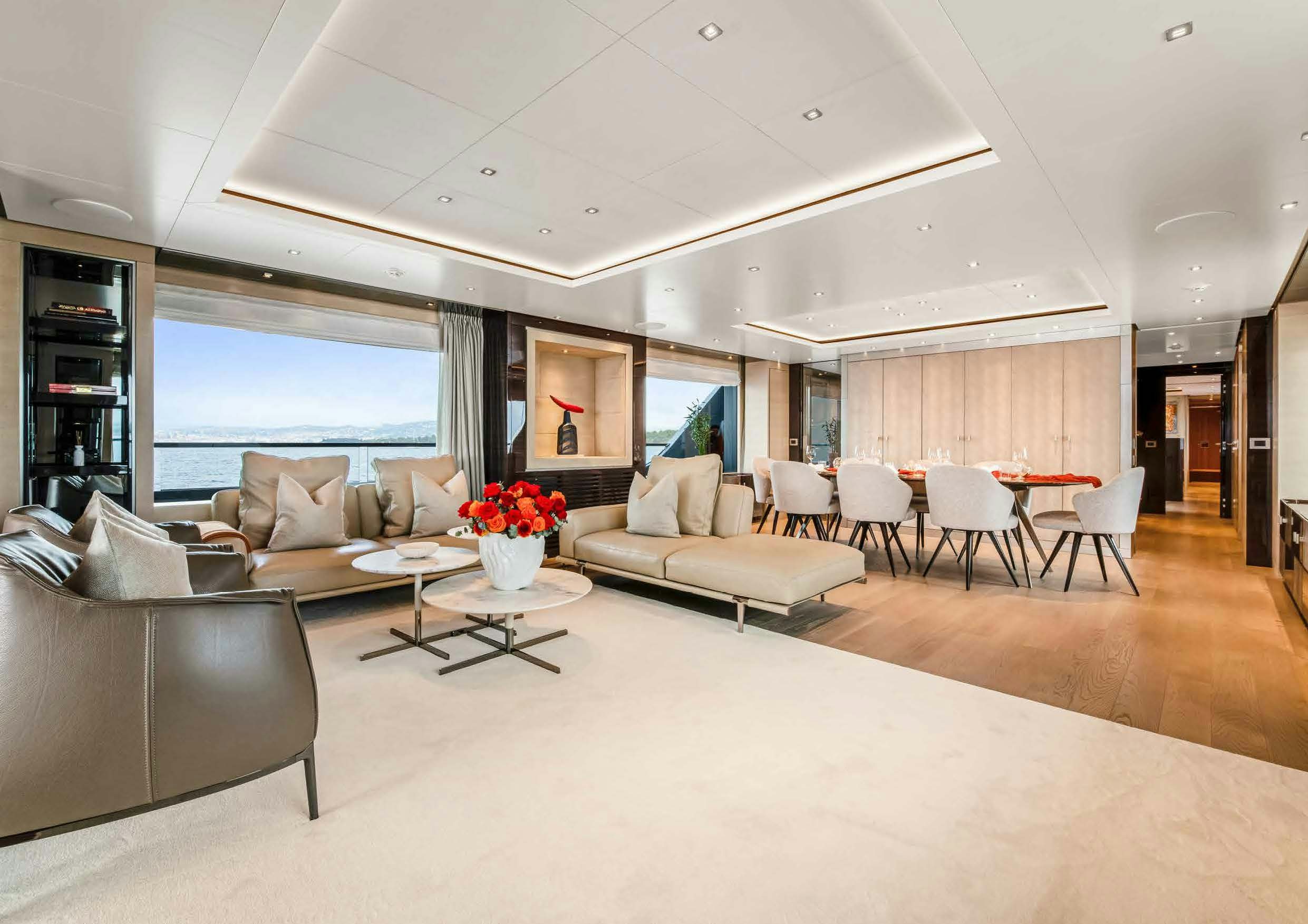 a living room with white furniture aboard NURI Yacht for Charter