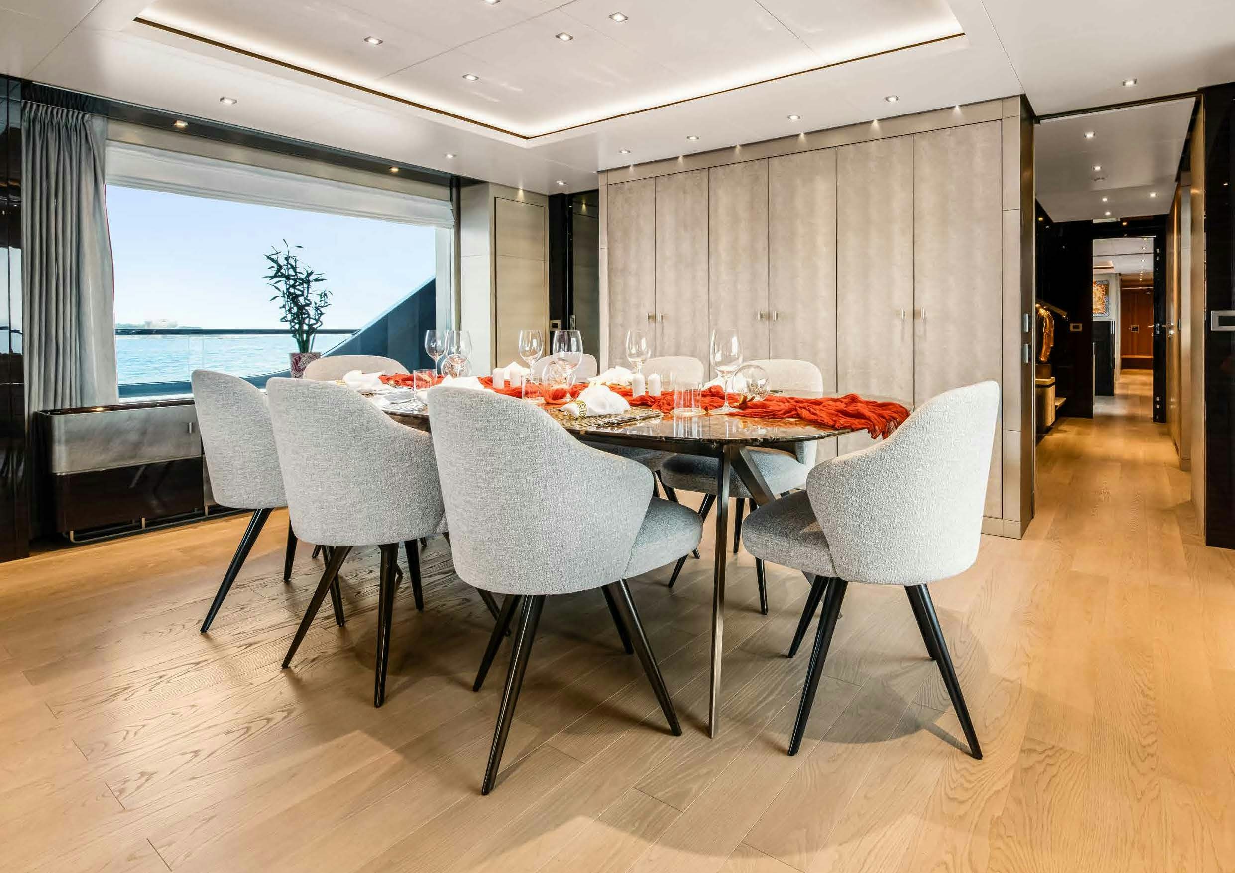 a dining table with chairs aboard NURI Yacht for Charter