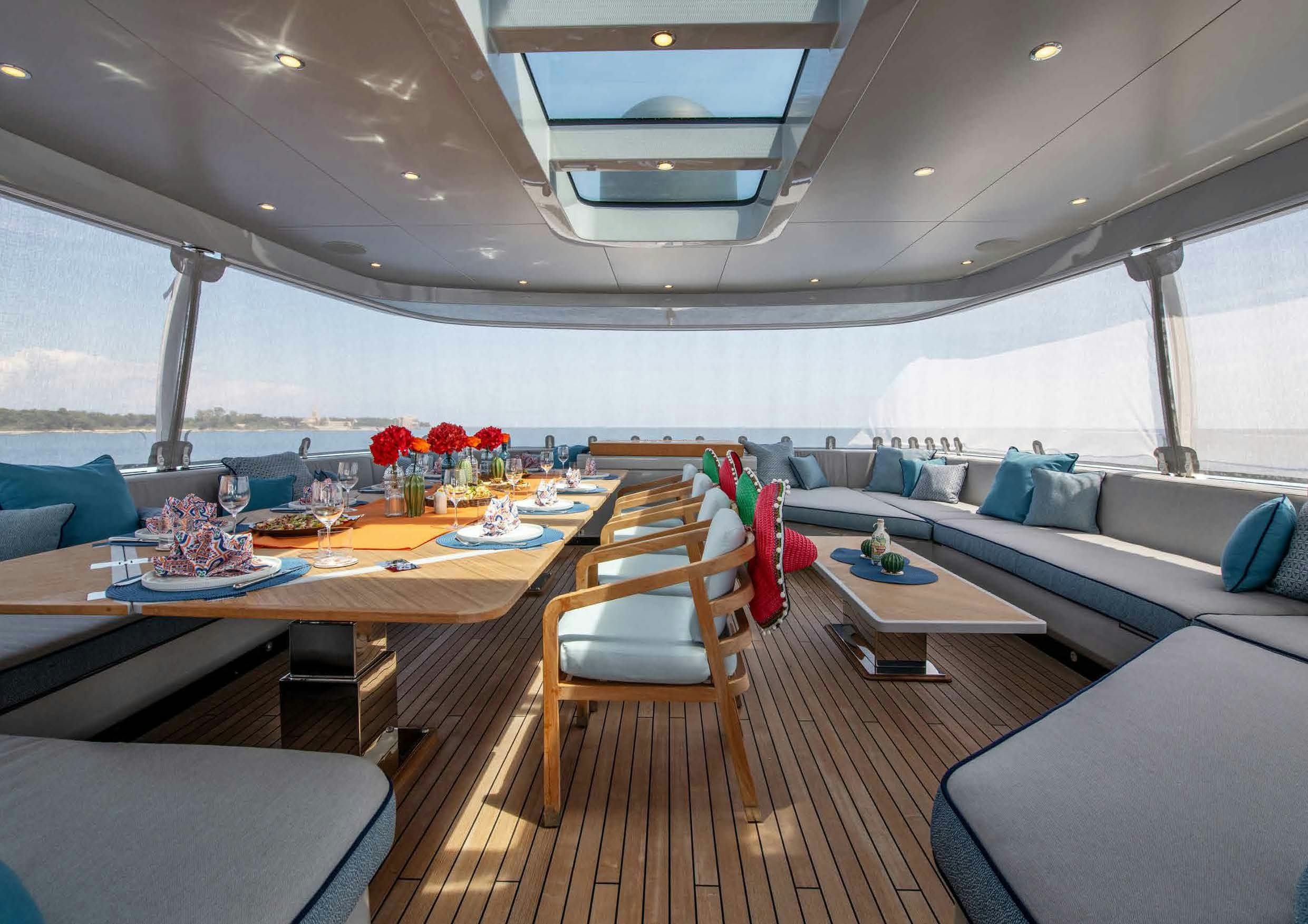 a room with a table and chairs aboard NURI Yacht for Charter
