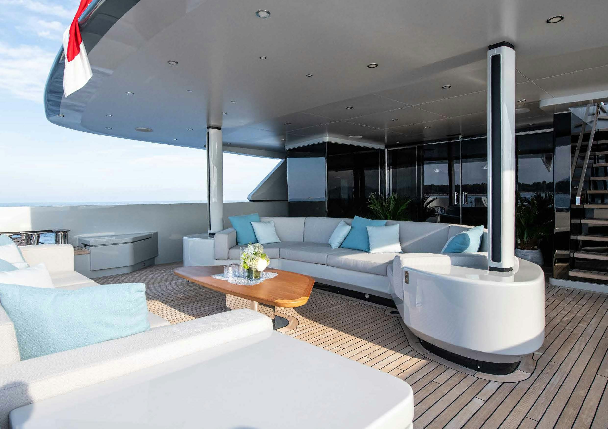 a modern living room with white furniture aboard NURI Yacht for Charter