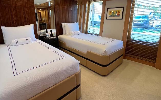 a couple of beds in a hotel room aboard SPORT Yacht for Charter