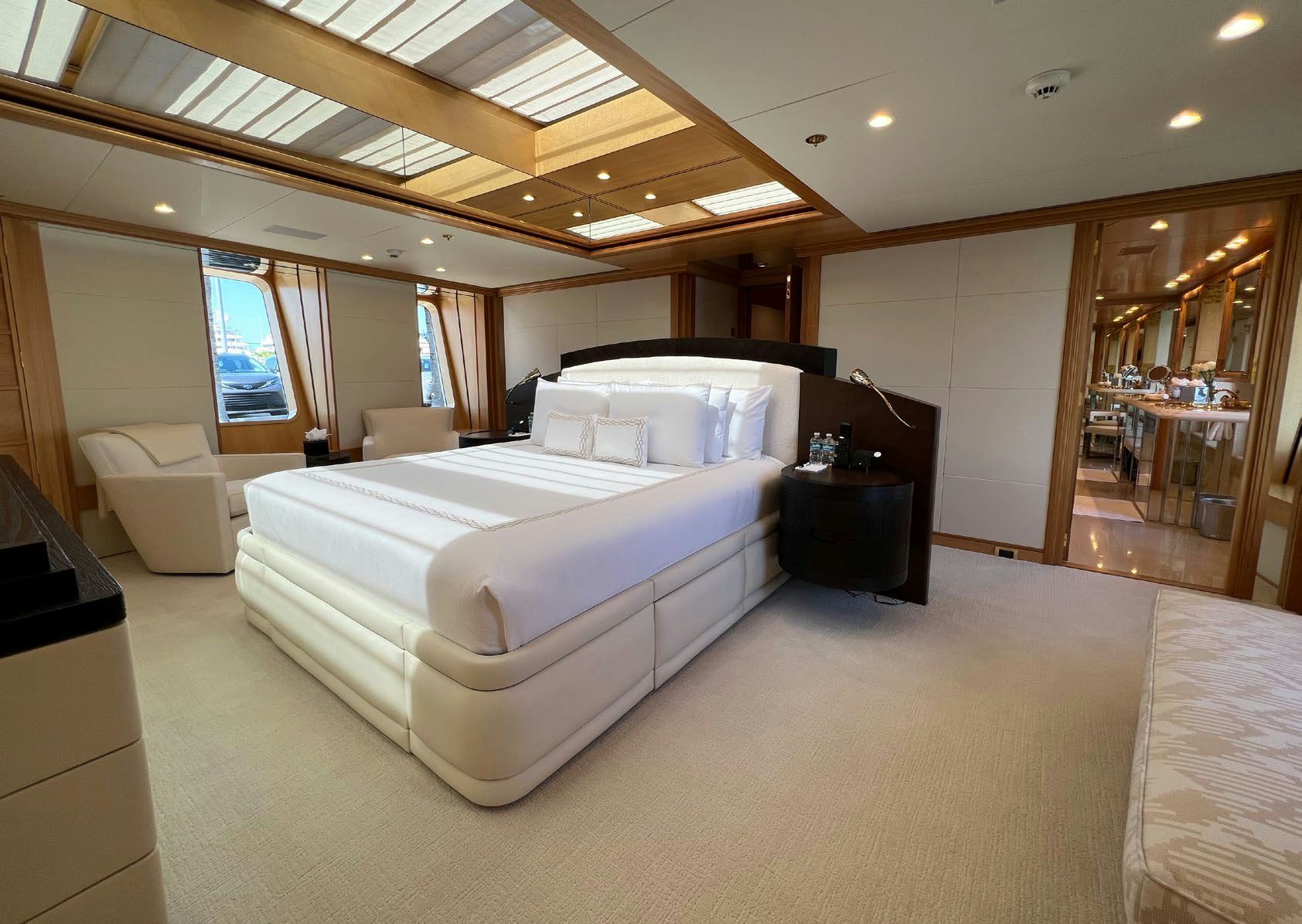 a room with a bed and a large mirror aboard SPORT Yacht for Charter