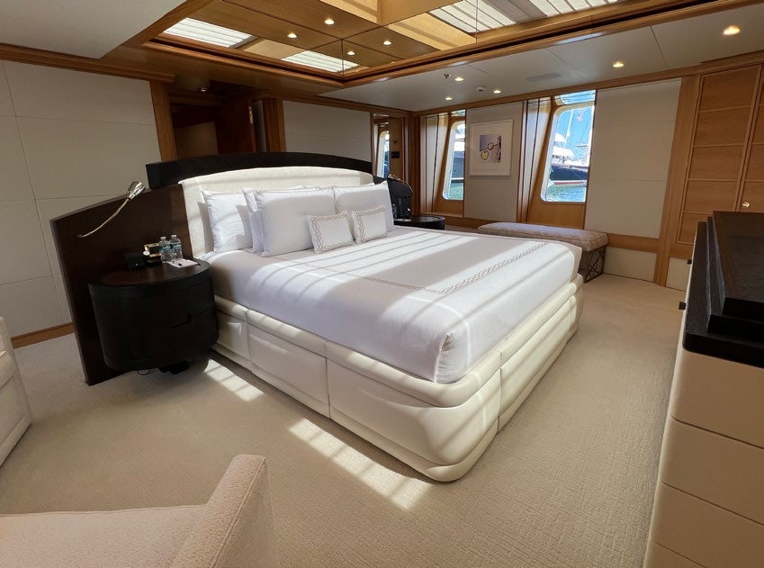 a room with a bed and a tv aboard SPORT Yacht for Charter