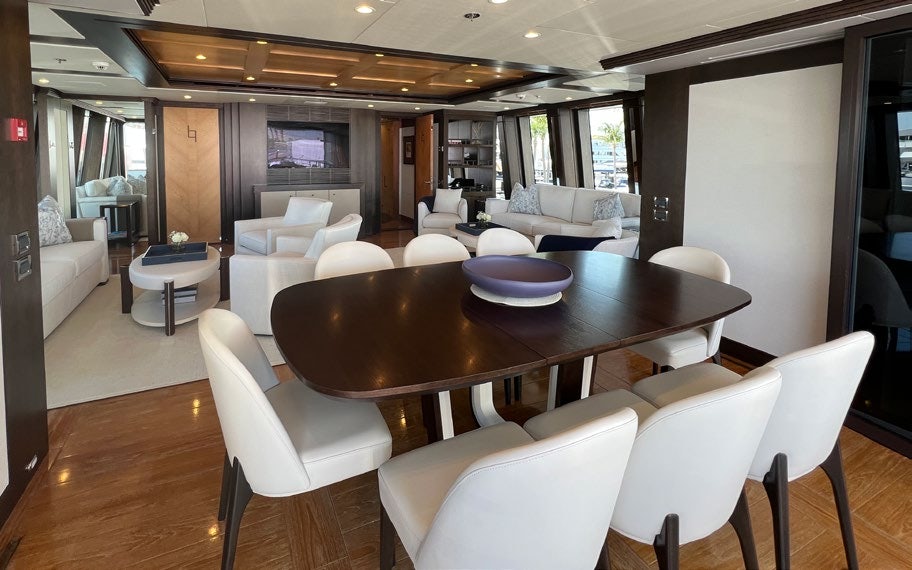 a dining room with a table and chairs aboard SPORT Yacht for Charter