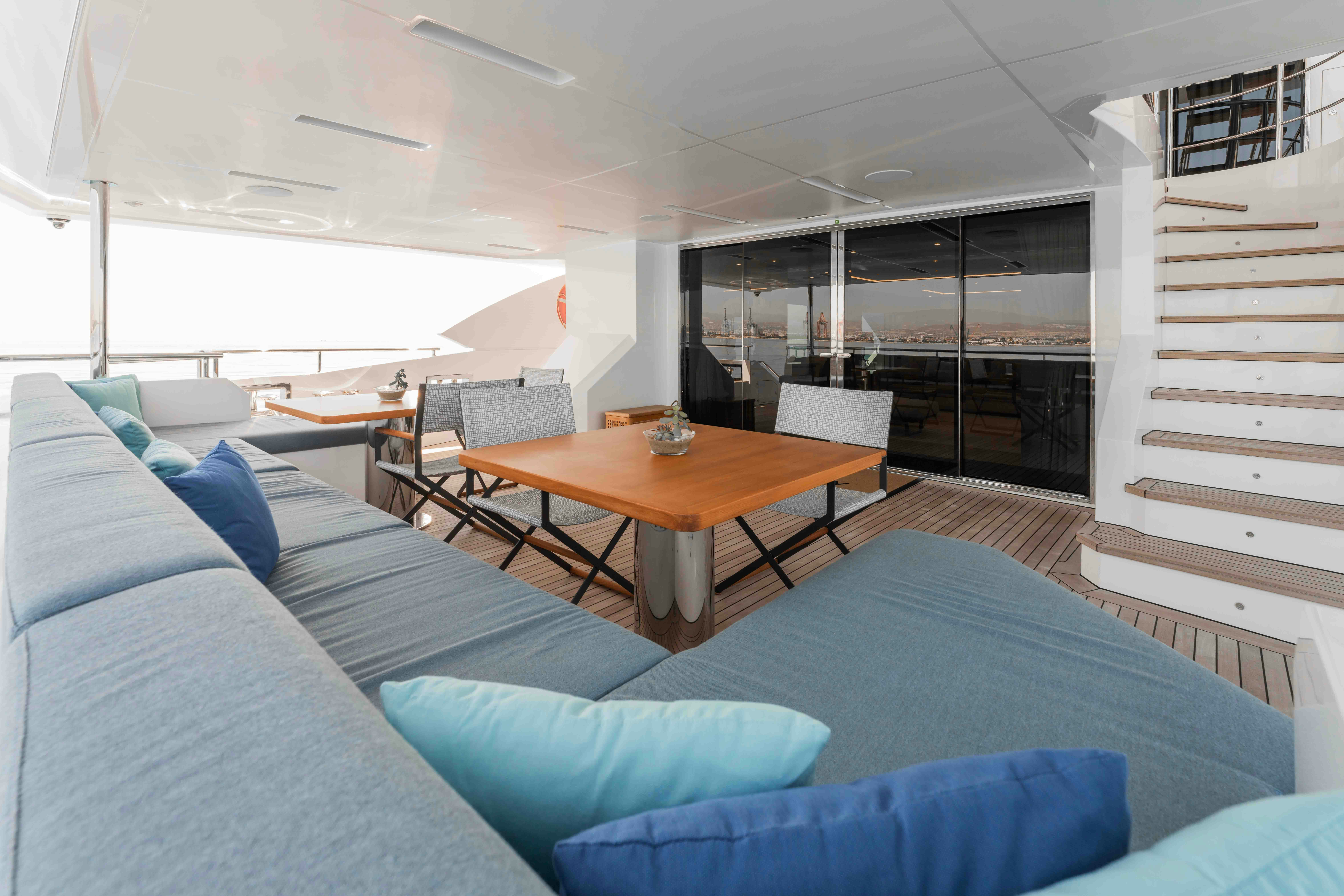 a room with a couch and a table aboard EXINITY Yacht for Sale