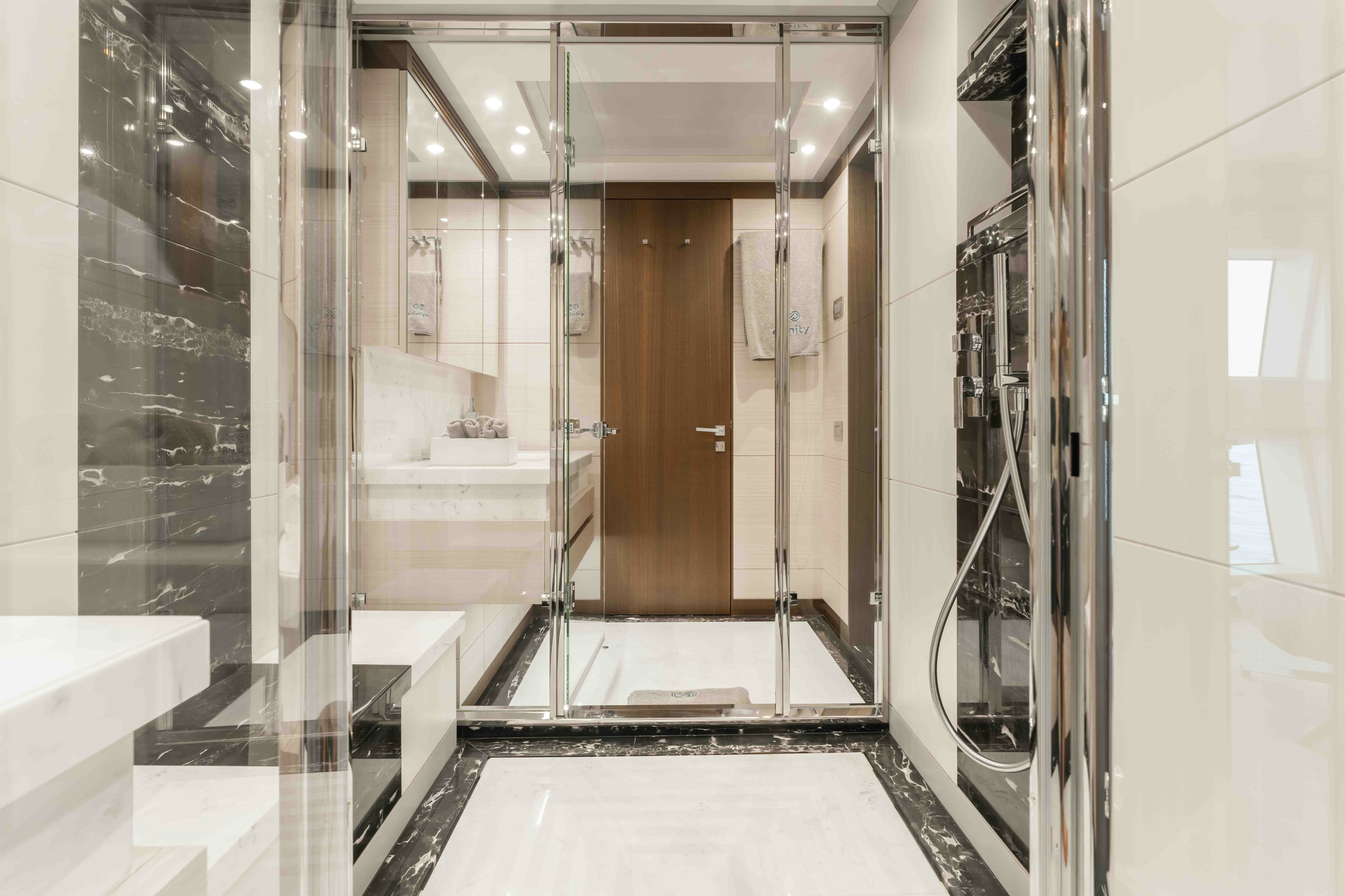 a bathroom with a glass wall aboard EXINITY Yacht for Sale