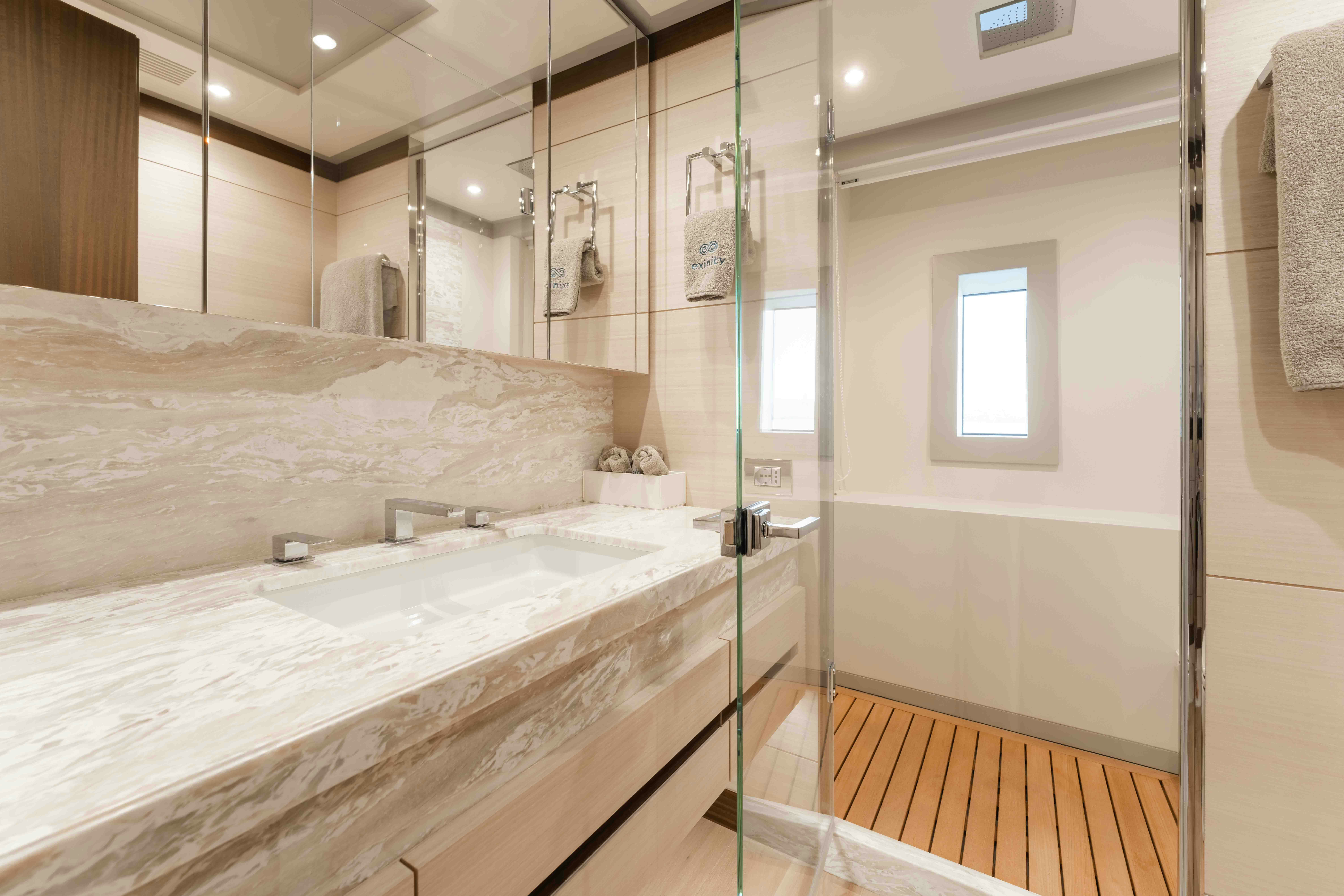a bathroom with a large mirror aboard EXINITY Yacht for Sale