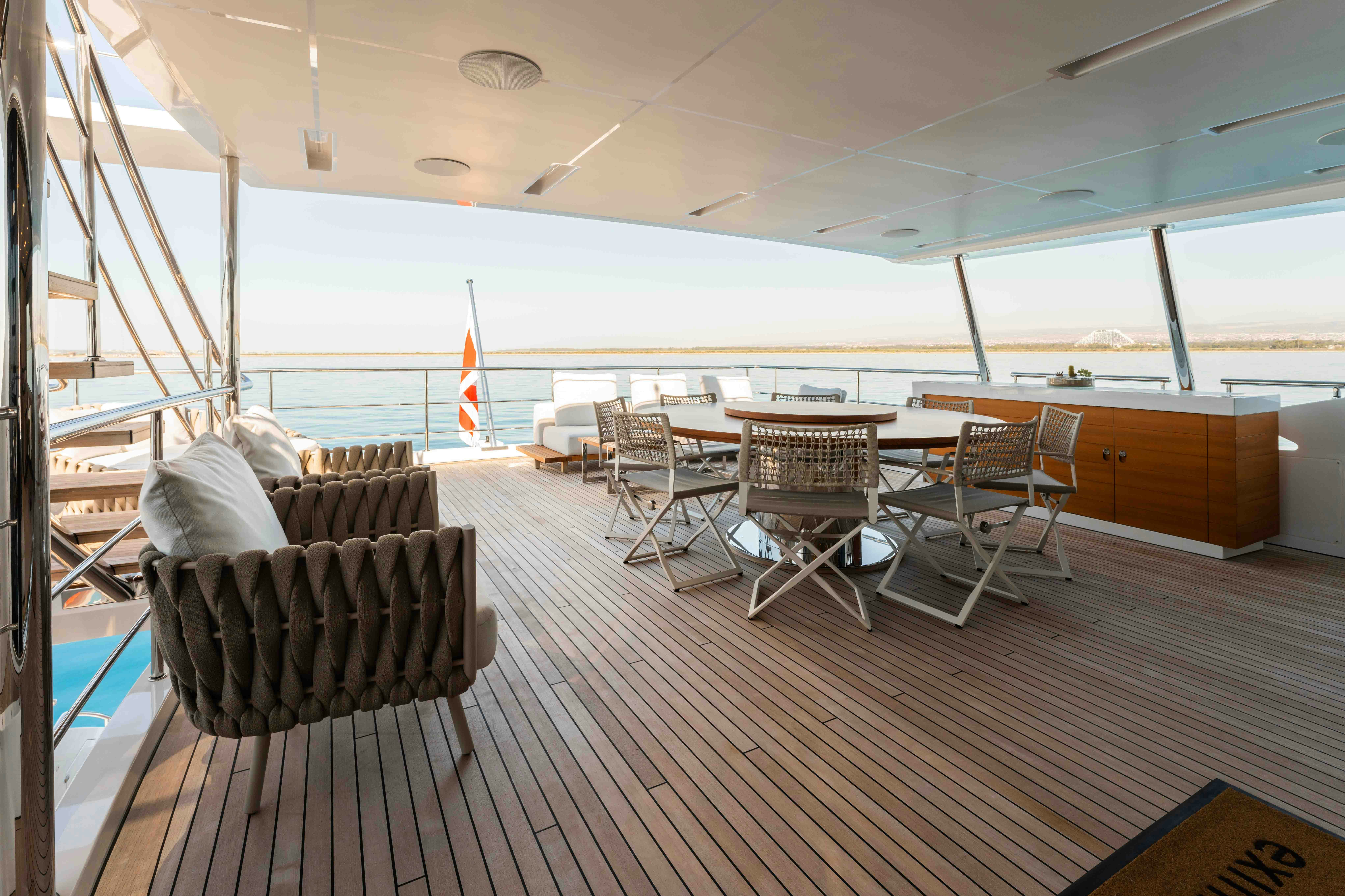 a room with a table and chairs aboard EXINITY Yacht for Sale