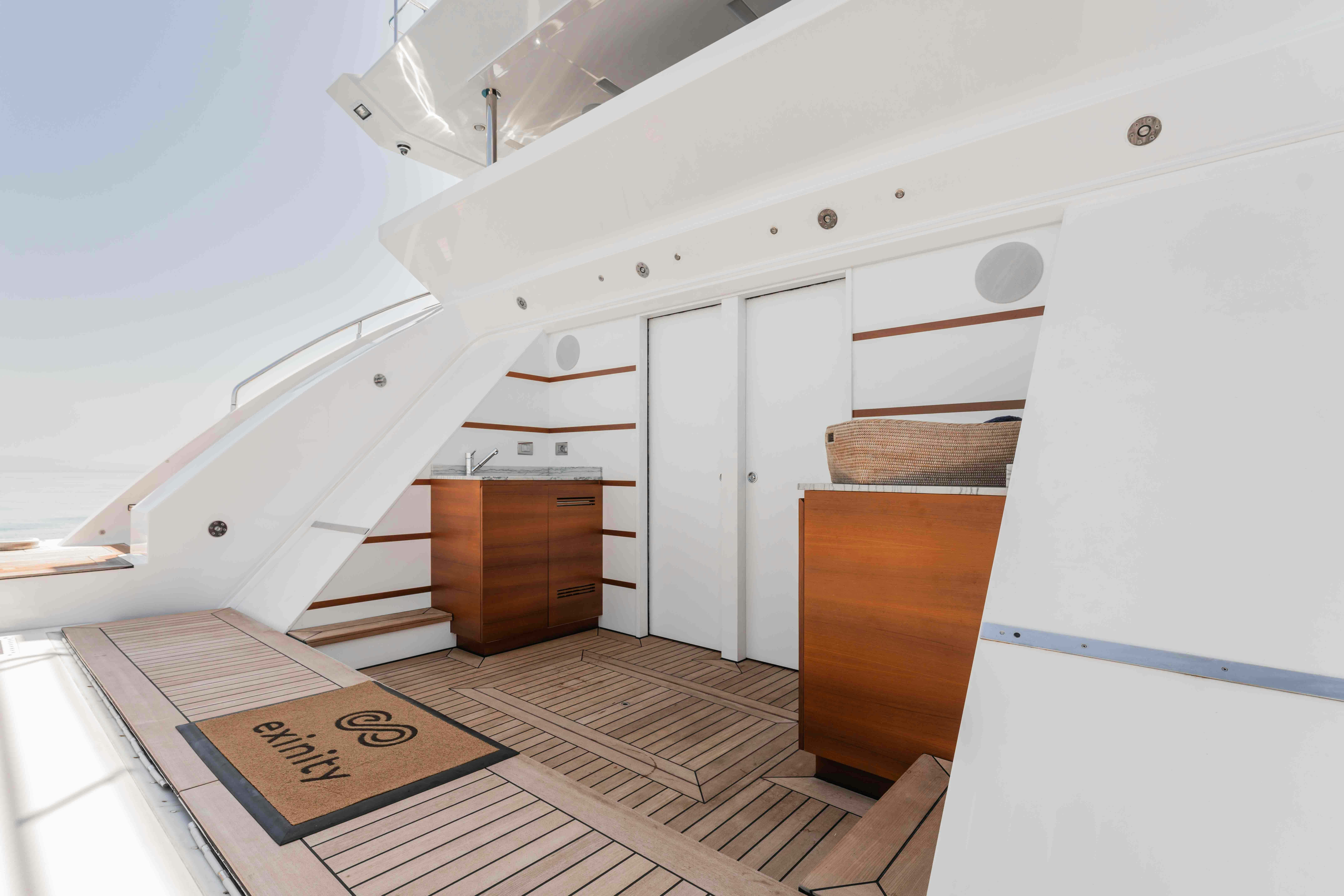 a white room with a wood floor and a wood cabinet aboard EXINITY Yacht for Sale