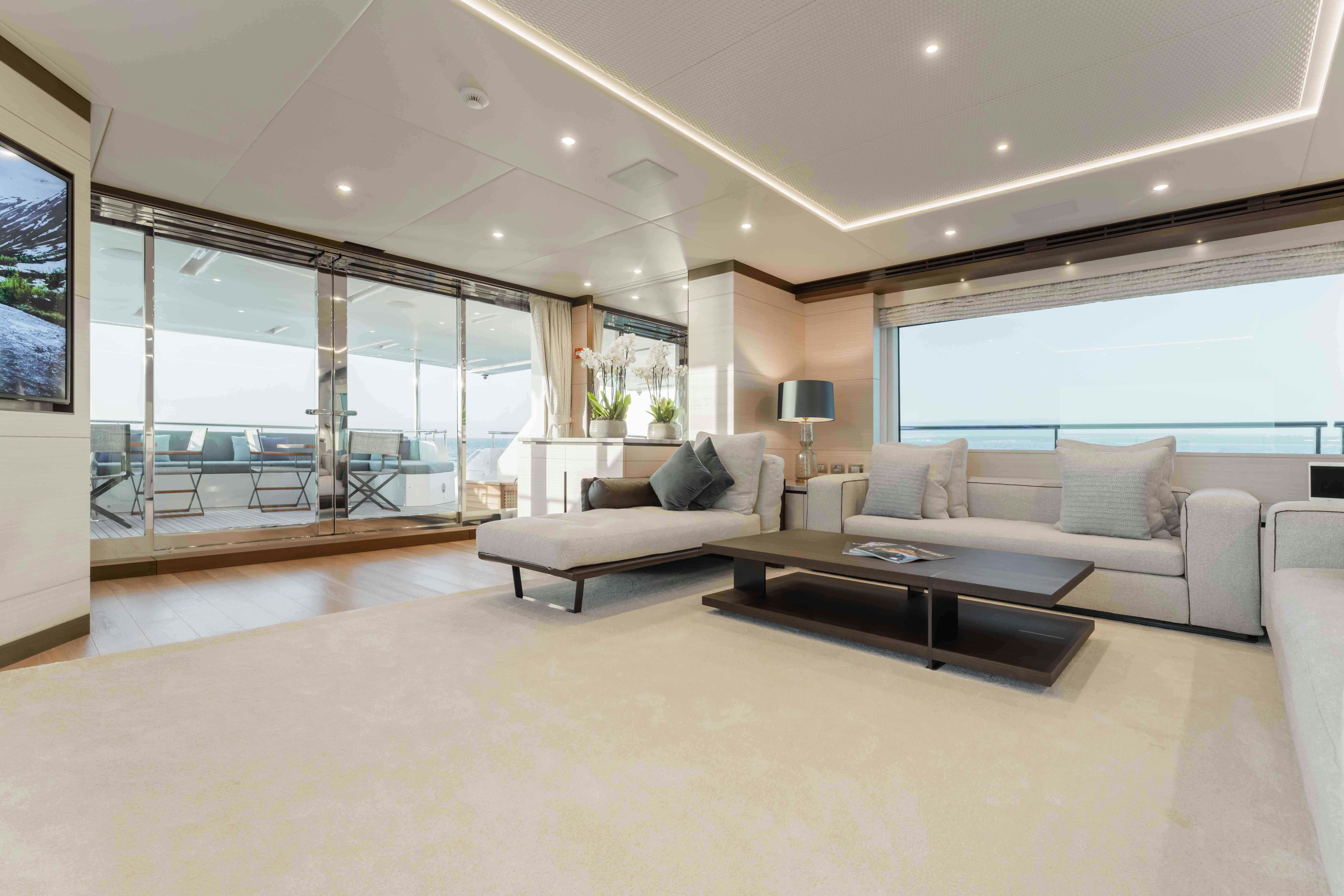 a living room with a large window aboard EXINITY Yacht for Sale
