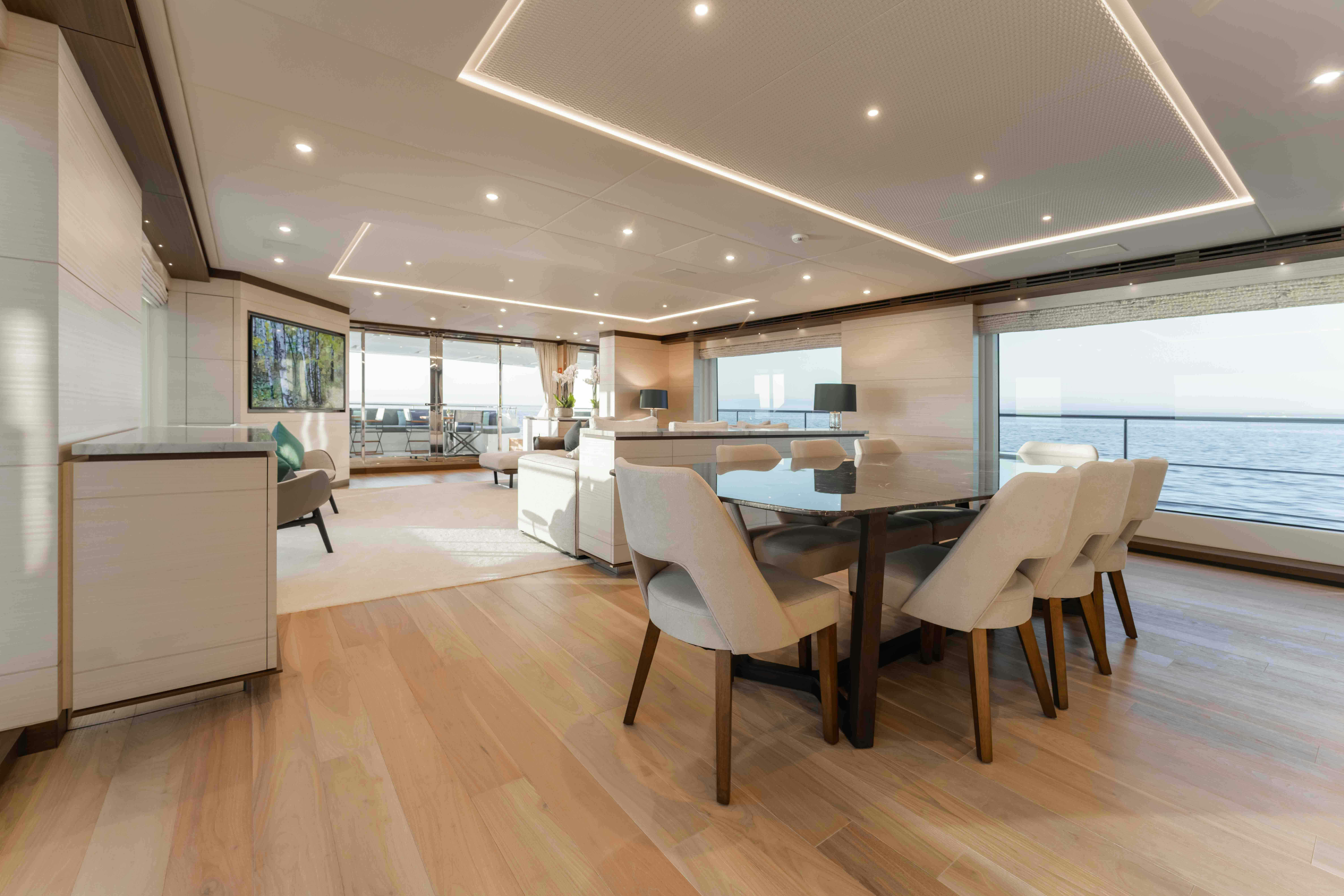 a room with a table and chairs aboard EXINITY Yacht for Sale