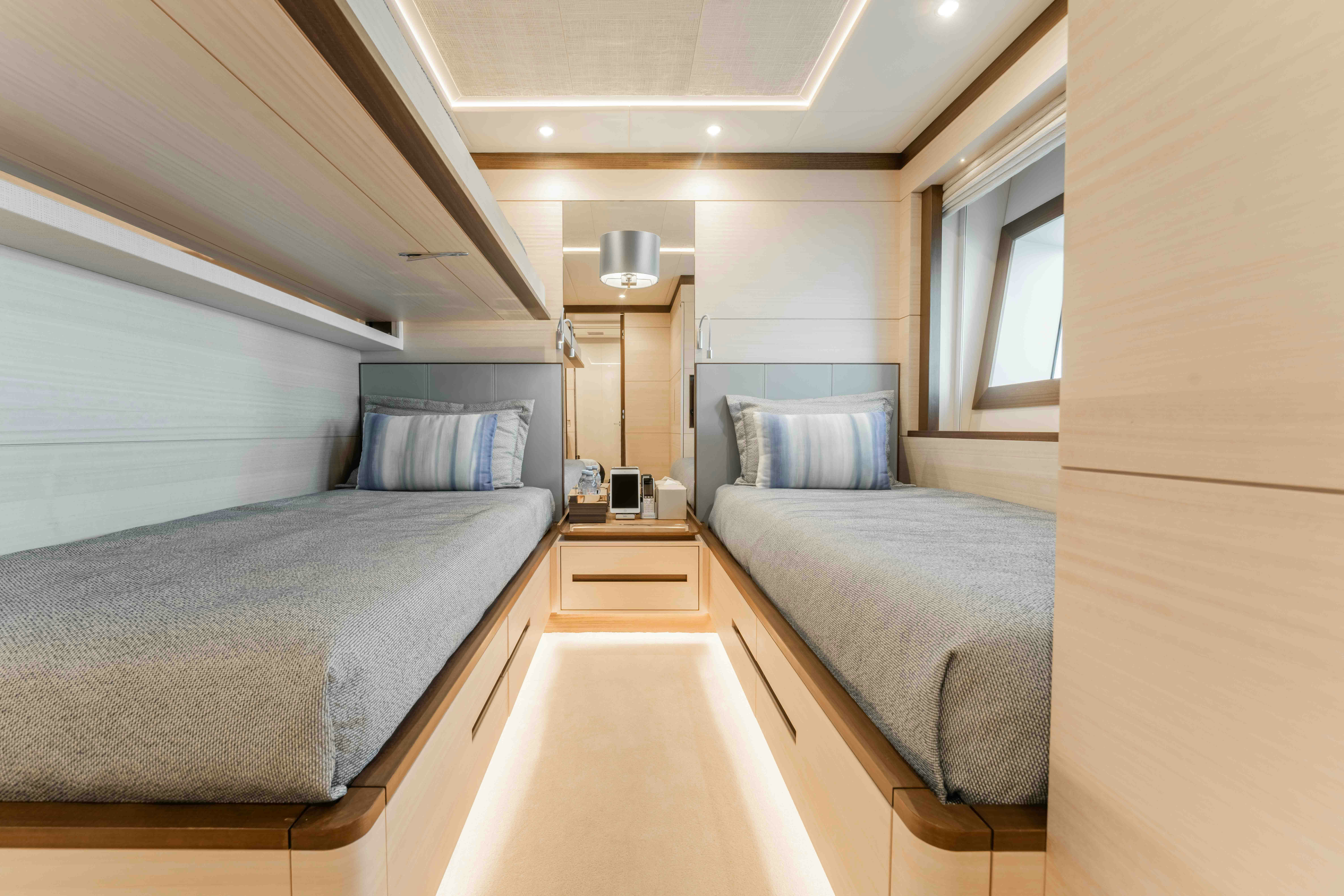a bedroom with two beds aboard EXINITY Yacht for Sale
