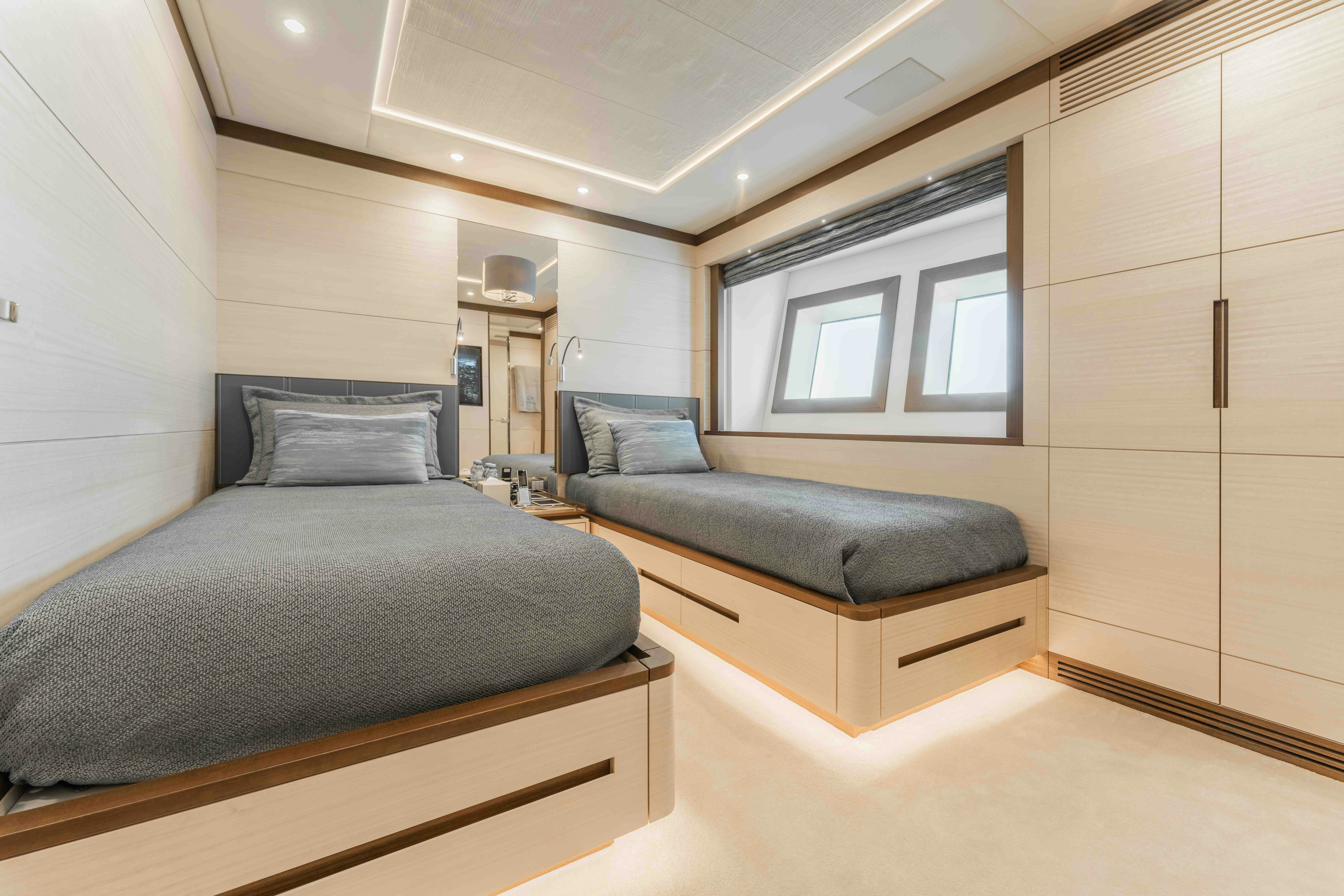 a bedroom with a bed and a couch aboard EXINITY Yacht for Sale