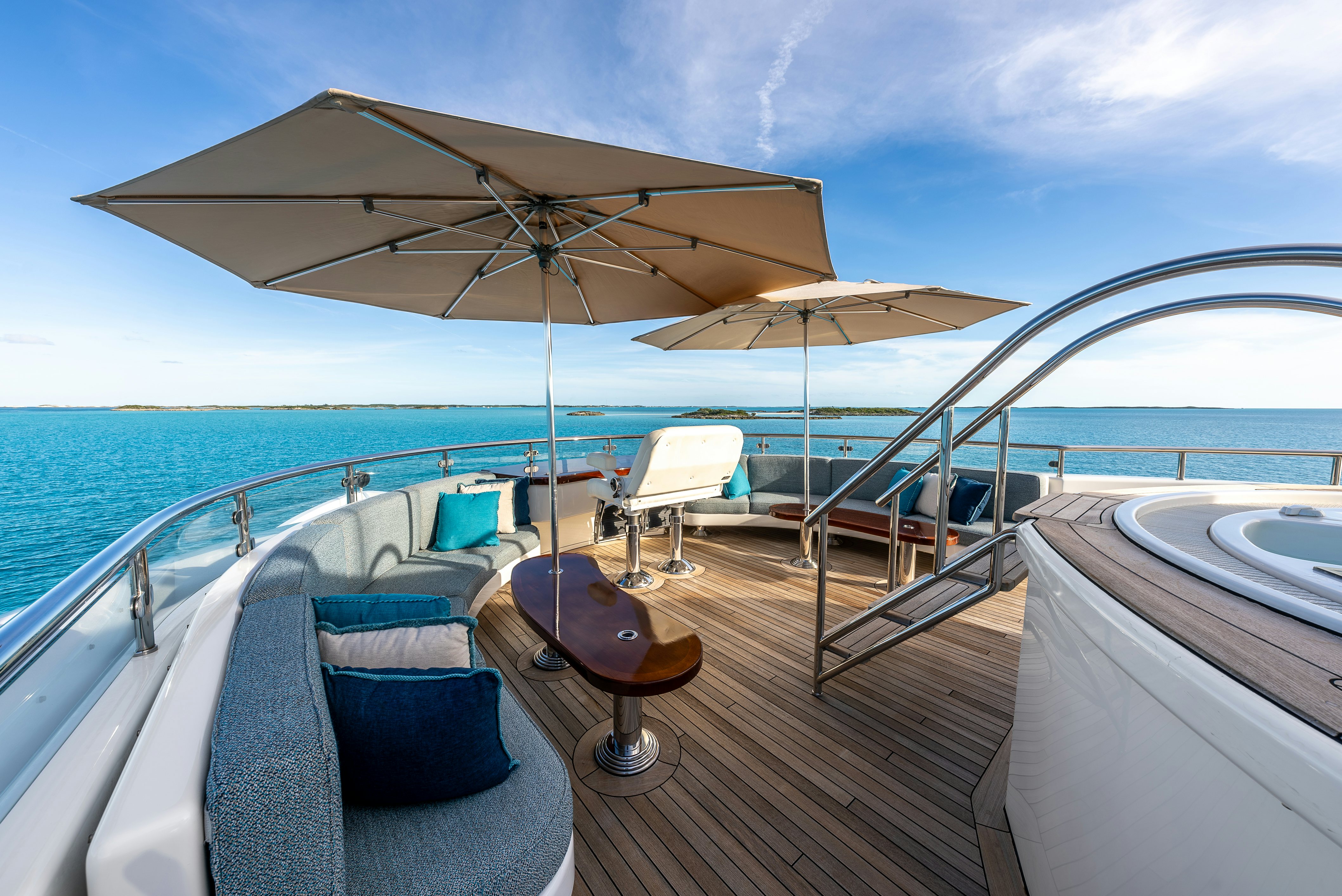 a boat with a table and chairs on a deck with a large umbrella aboard VALINOR Yacht for Sale