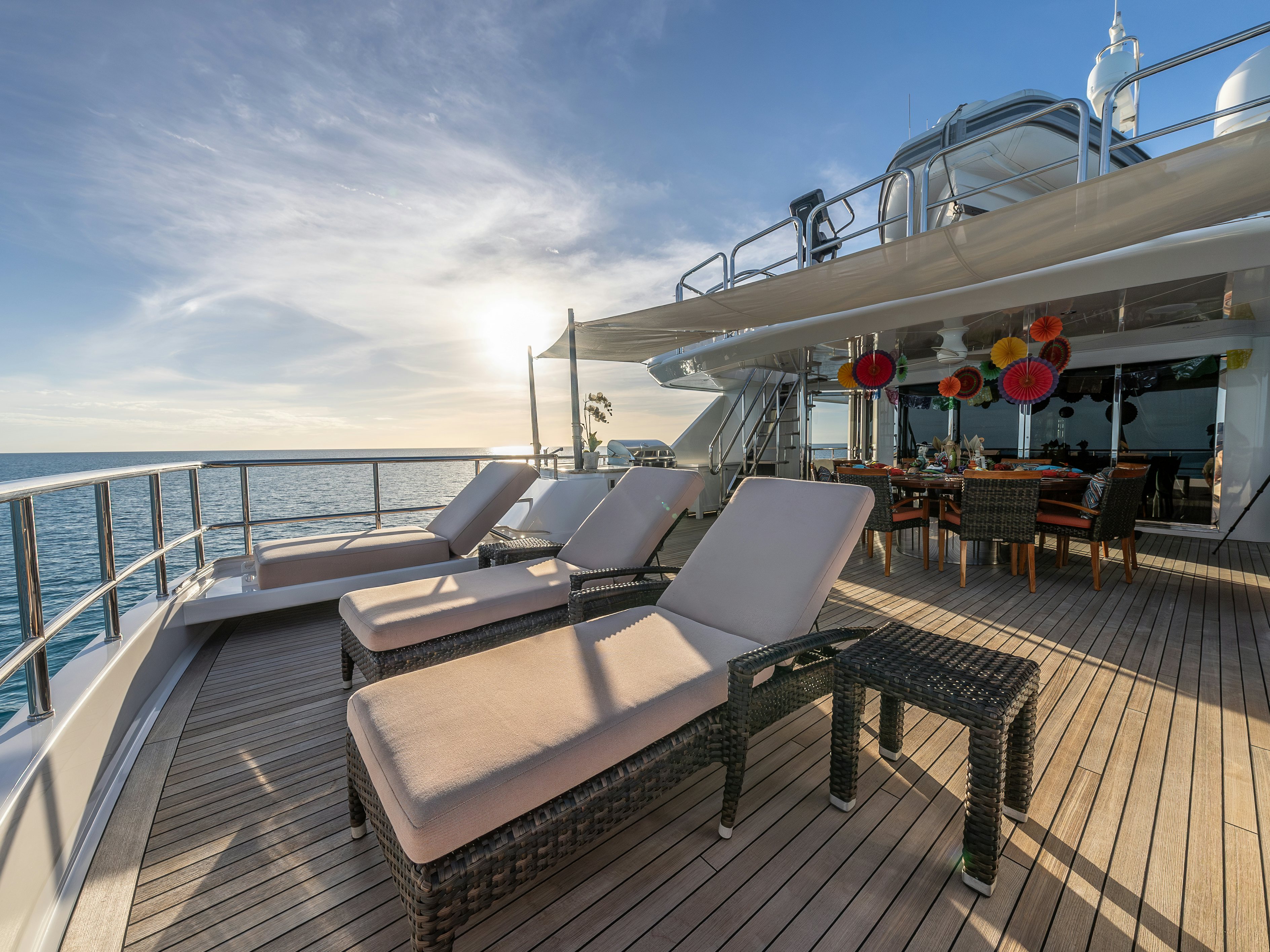 a deck with chairs and tables on it aboard VALINOR Yacht for Sale