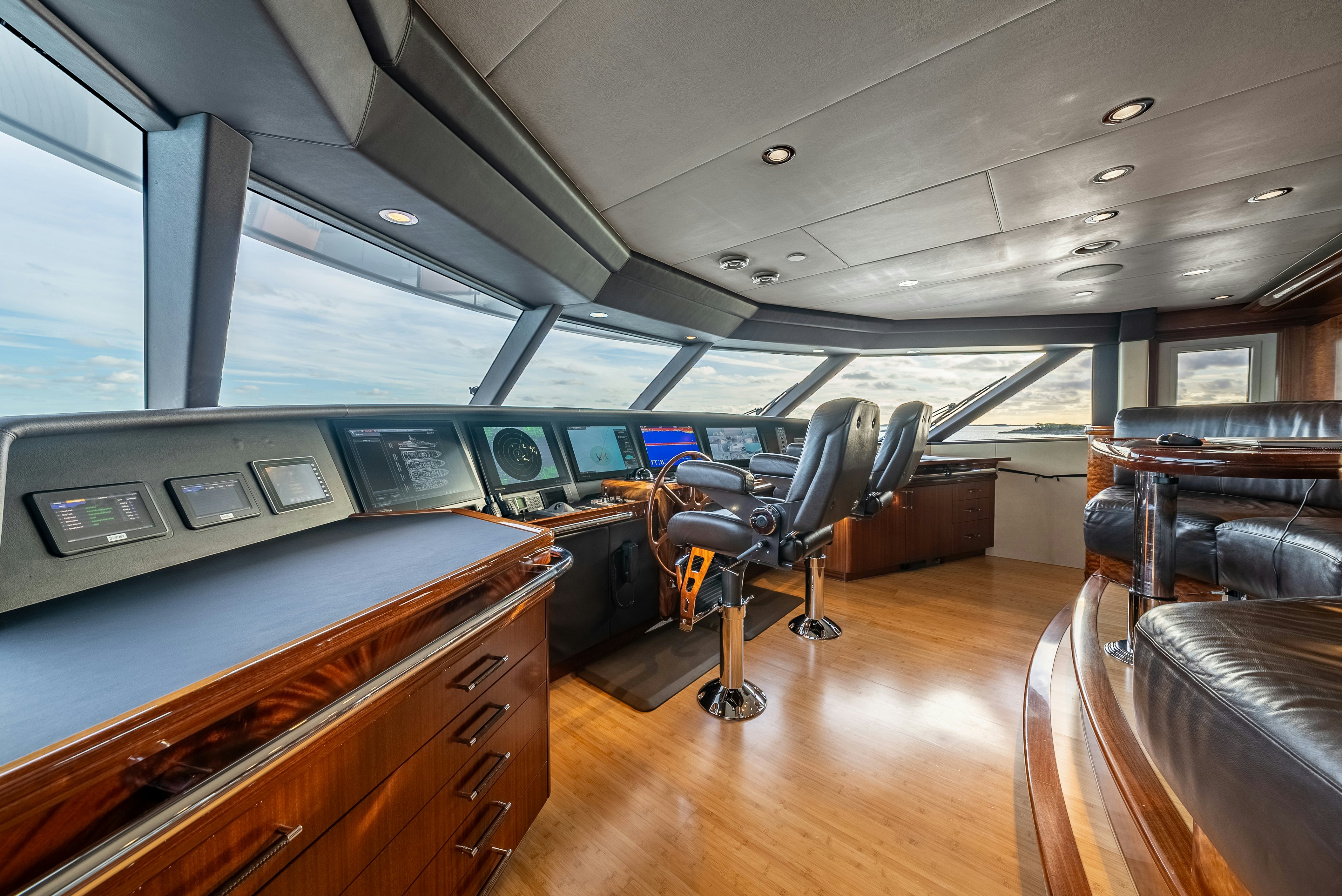 a room with a desk and chairs aboard VALINOR Yacht for Sale