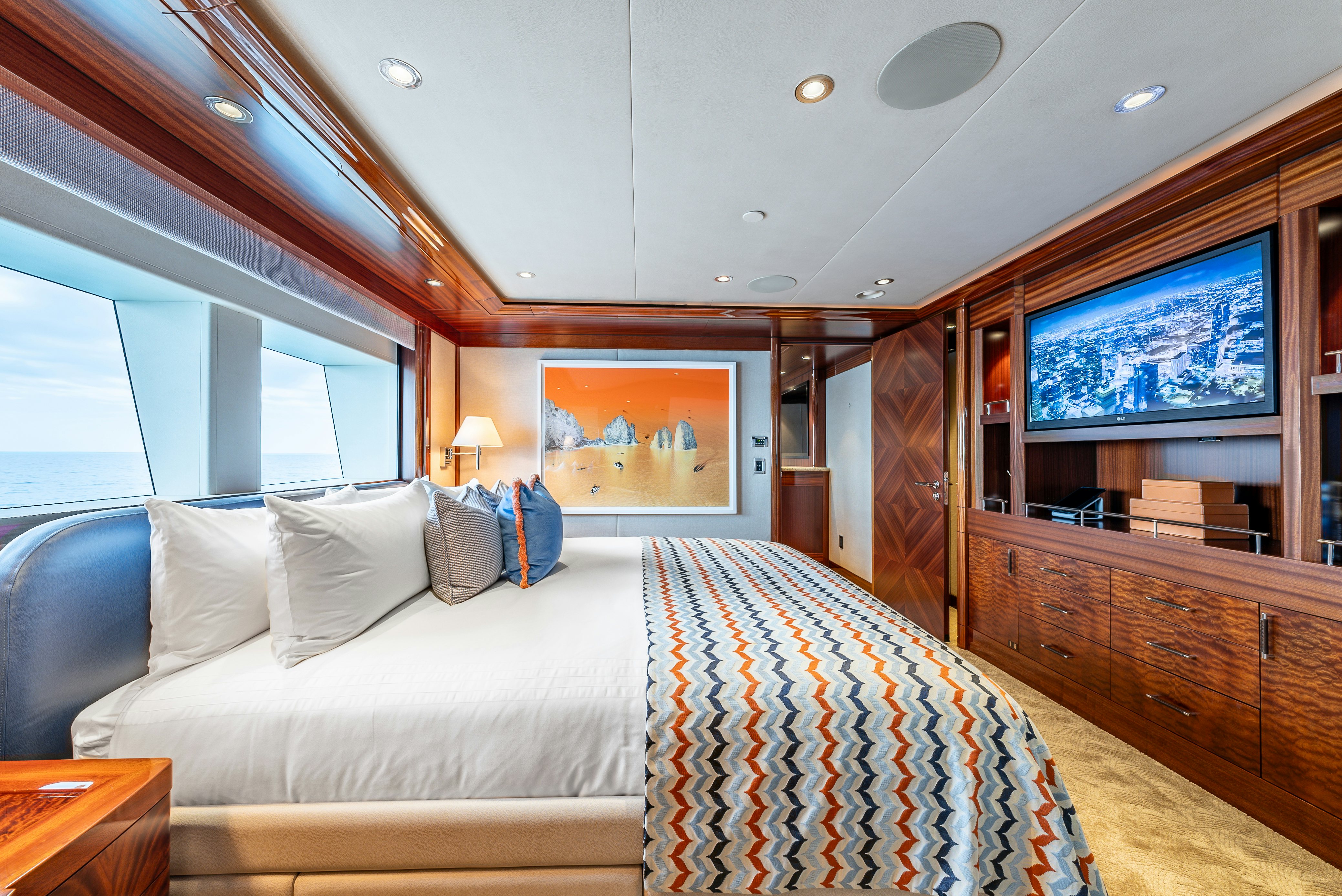 a bedroom with a bed and a window aboard VALINOR Yacht for Sale