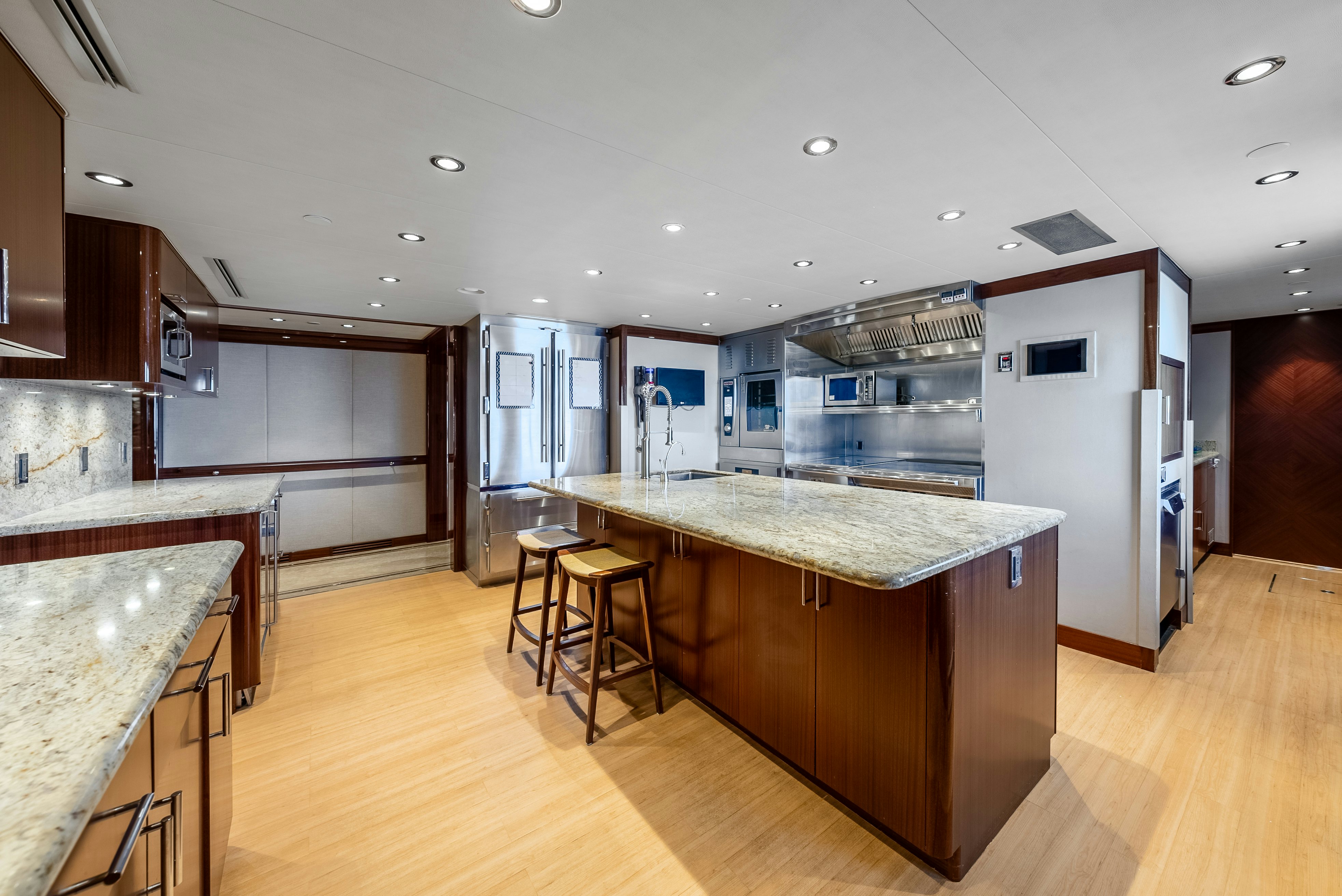 a kitchen with a large island aboard VALINOR Yacht for Sale