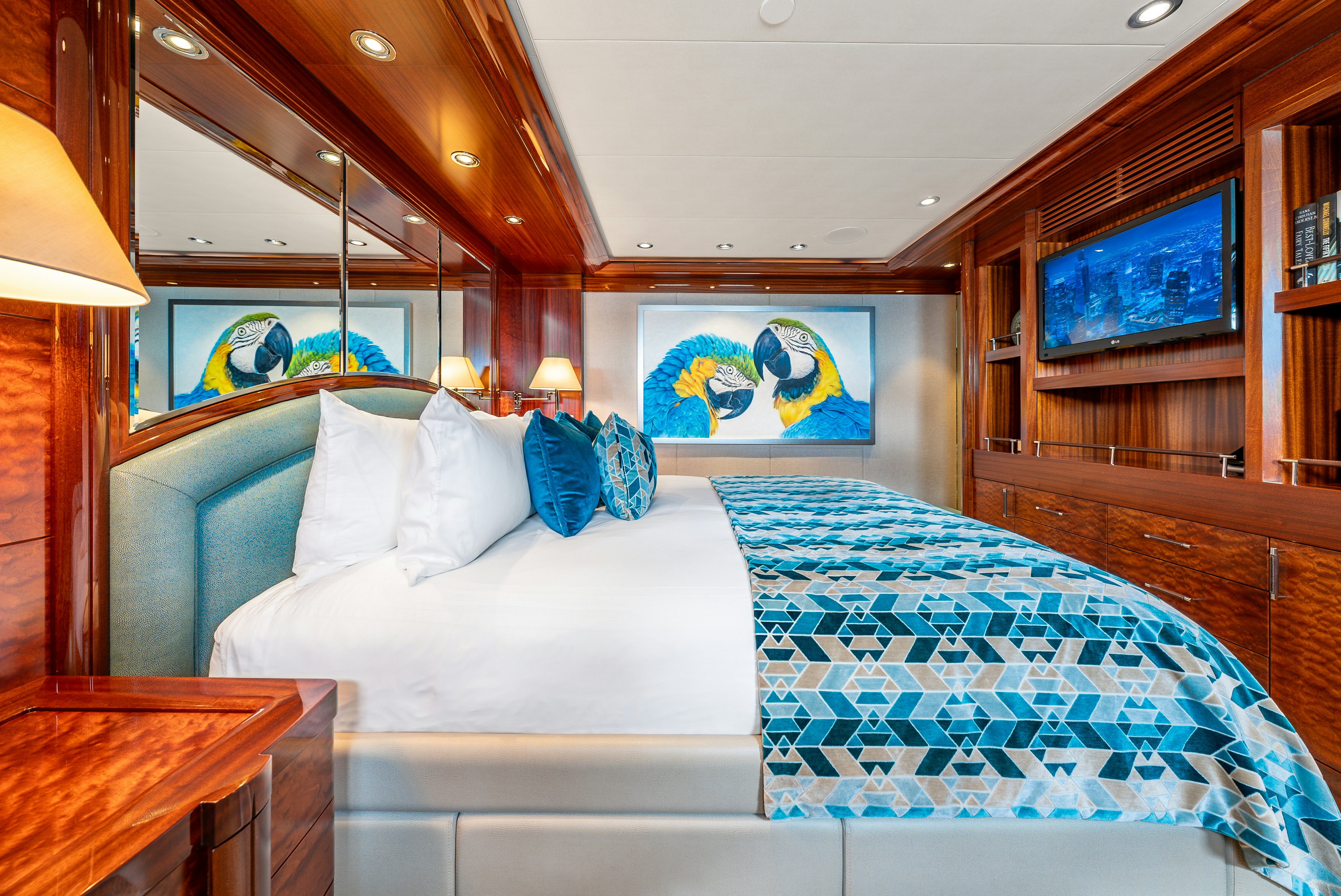 a room with a bed and a television aboard VALINOR Yacht for Sale